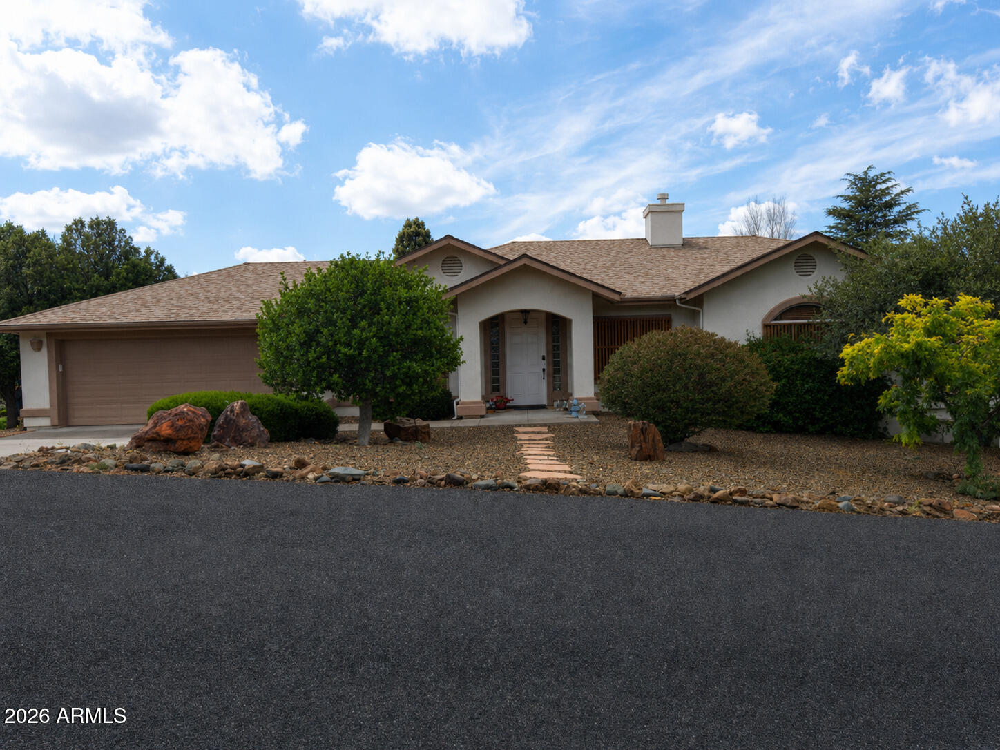 Beautifully updated 4BD/3BA walkout basement home in Prescott Country Club with 2,750 sq ft of living space. Main level features vaulted ceilings, fireplace, granite island kitchen with hickory cabinetry, dining area, breakfast nook, laundry room, primary suite, and two additional bedrooms. Walkout lower level offers a spacious great room, second living area, fourth bedroom with walk-in closet, and den. Enjoy covered deck, balcony, and patio areas, plus two attached 2-car garages (one oversized), RV parking, and a fenced backyard with raised garden beds, fruit trees, and flagstone pathways. Recent updates include a new roof (2024), interior paint, carpet, fixtures, and door hardware. Abundant storage, custom built-ins, water softener, and security system complete this home.