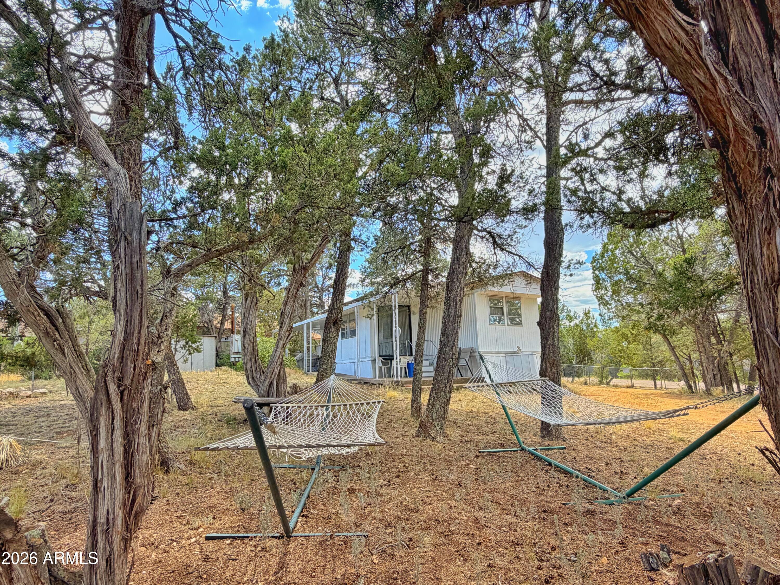Beat the heat with this affordable mountain getaway in the heart of Arizona's White Mountains! This charming home offers 1 bd/1ba on a spacious 0.45-acre double lot fully furnished and fenced! The additional parcel features its own septic system, RV parking and hookups, outdoor recreation, gardening, or future improvements. Enjoy the privacy and flexibility of a large, fenced lot while still being conveniently located near outdoor activities, fishing, hiking, and all the recreation the mountains have to offer. Don't miss this unique opportunity to own an affordable piece of mountain living with space to make it your own!