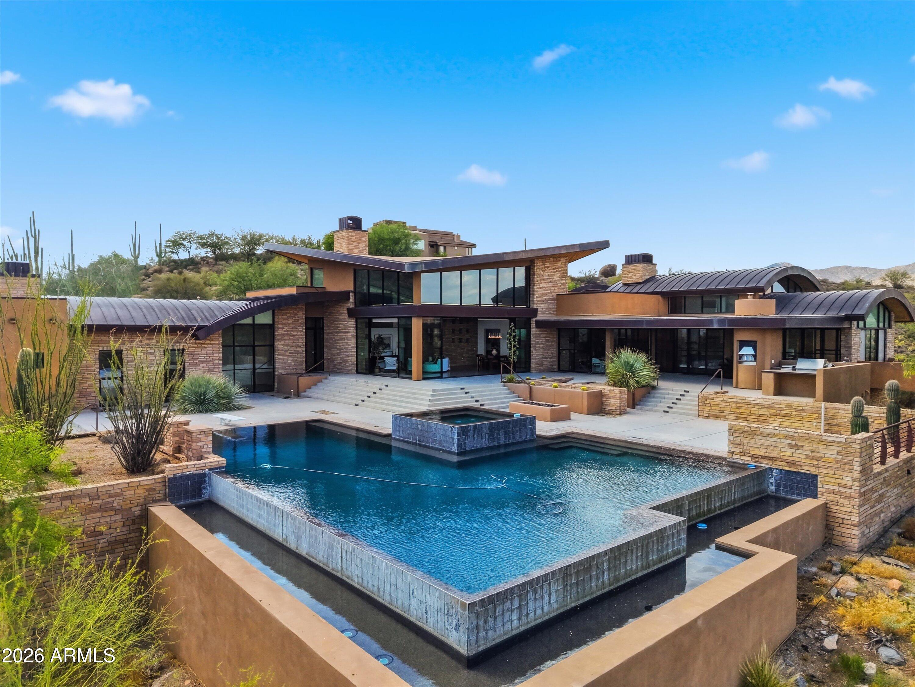 Fantastic Opportunity to own this Desert Mountain SPECTACULAR CUSTOM HOME!! High in the Majestic Mountains of this Exclusive Private Golf course Community, this Amazing Masterpiece awaits you! Sitting on 4.5 acres of natural desert landscape, this Mountaintop Estate has Sweeping Views of the valley all the way to Camelback Mountain. Boasting over 6,000 sq ft of Living space, this sprawling 6-bed 7-bath, split floor-plan All are en-suites. Steel frame construction. Seamless Indoor & Outdoor flow, an impressive negative edge pool & spa, and an outdoor kitchen w/ pizza oven & BBQ, overlooking breathtaking panoramic views! Solid Home w/Built-in Equity & Upside! & a Huge, Value-Add Opportunity! YOU MUST SEE THIS ONE TO BELIEVE IT!