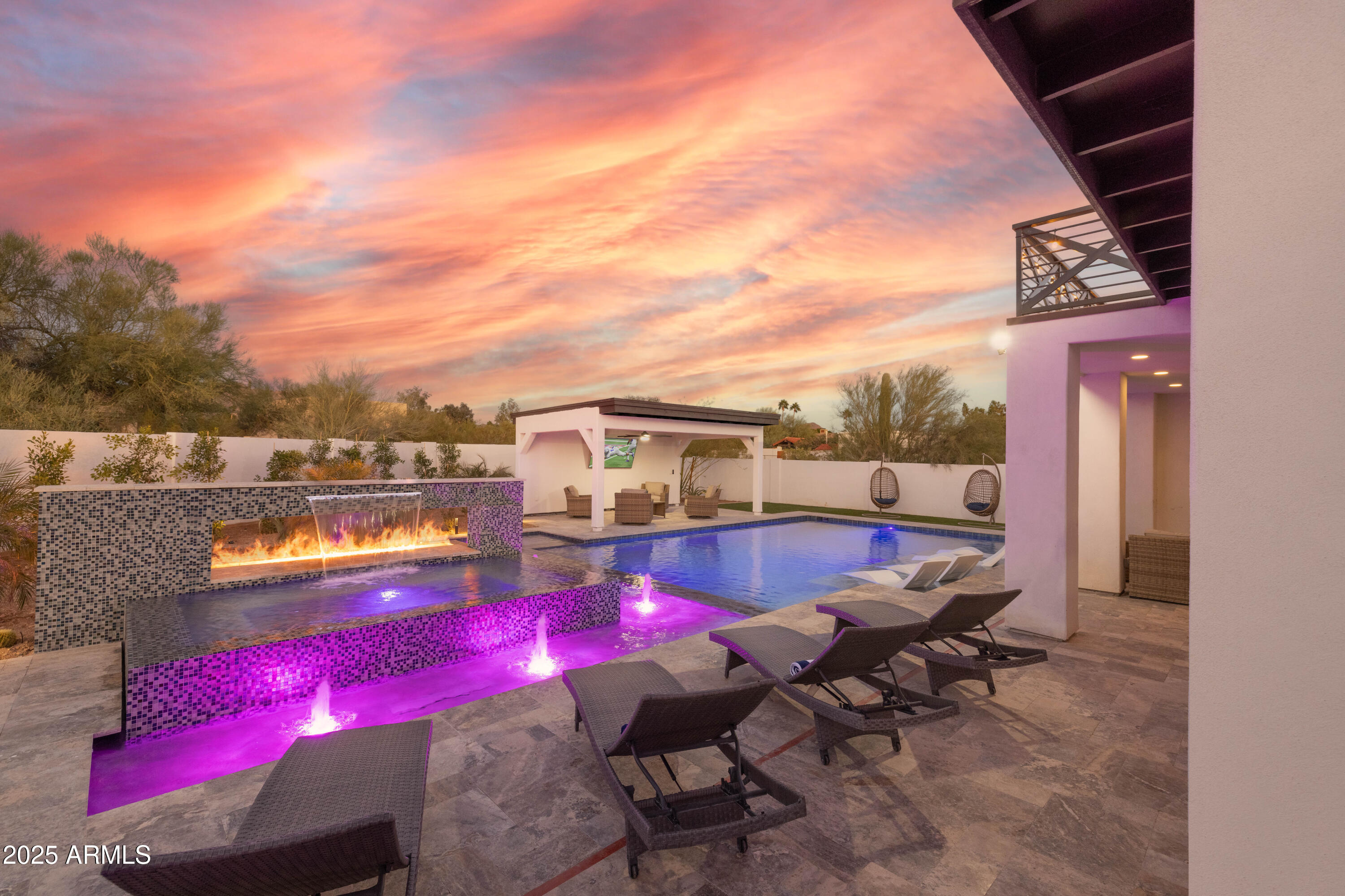 Wait until you see this amazing freshly remodeled home surrounded by the beautiful MOUNTAINS & DESERT landscape & one that aligns a lifestyle of tranquility & positive energy! The BOLD Iron entry door, vaulted ceilings, upgraded fixtures & cantera stone finishes around the fireplace truly makes a statement throughout the home. Full home theatre, Total of three Master BR's, custom kitchen features 42'' wood cabinetry, granite stone countertops, custom fan hood, built-in SS fridge, WOLF cooktop & dual ovens sure to please the pickiest of chefs.  The 1350 SF detached casita features a master suite, three additional bedrooms, bathroom and kitchen area perfect for guests or as an income opportunity. The backyard features a resort style pool and landscape perfect for outdoor entertaining.