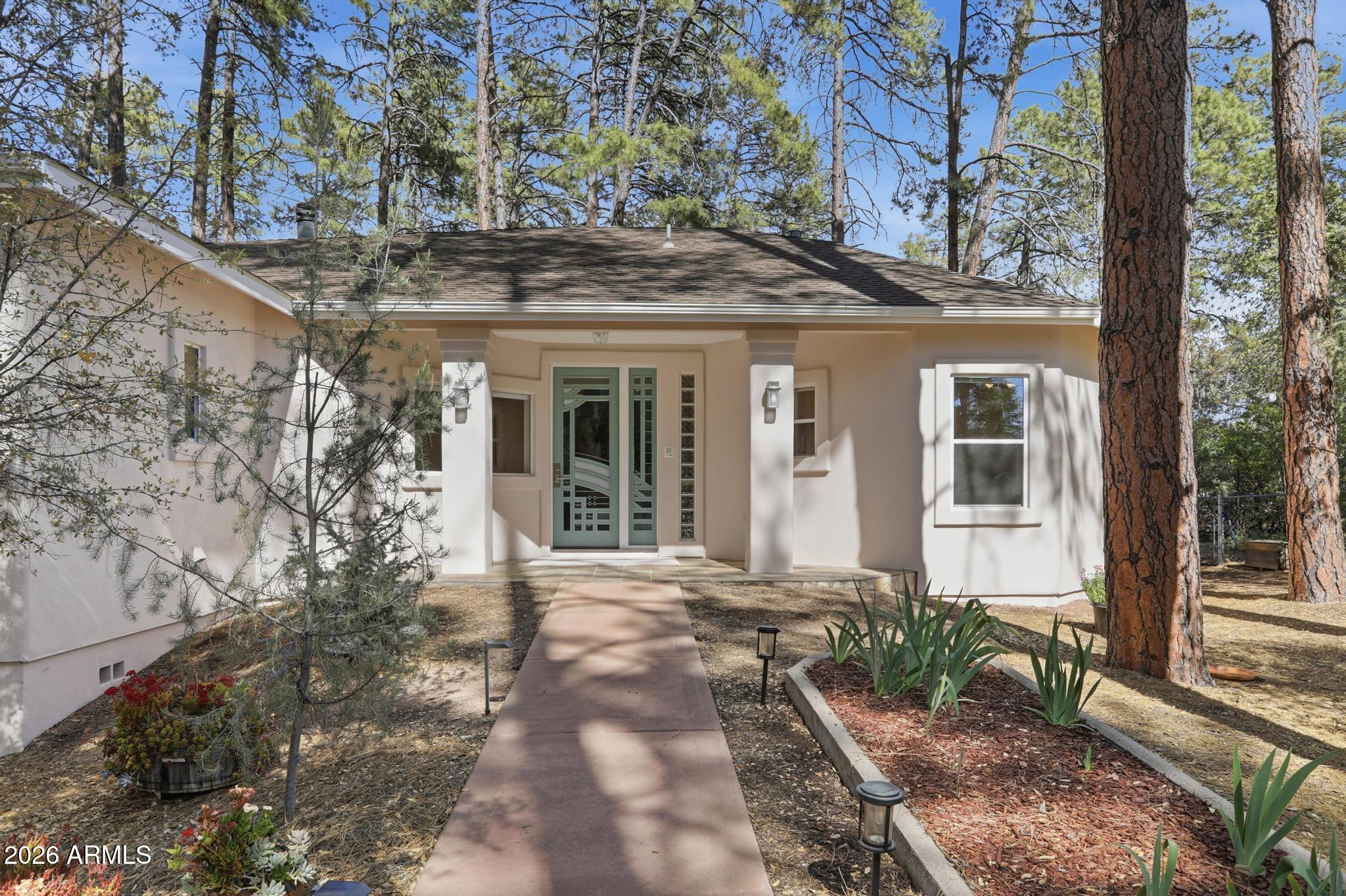 Nestled in a cul-de-sac among nearly 100 majestic Ponderosa pines on a private, fully fenced acre, this meticulously maintained custom home offers privacy, beauty, and exceptional pride of ownership.

This home is complete with fresh exterior paint, a recently repaired roof, cold A/C replaced in 2023 and a new tankless water heater. Other features include solid red oak flooring, an induction cooktop, reverse osmosis and water softener systems, a striking stone fireplace, a sun-filled sunroom, and a private primary suite complete with its own fireplace.

The two covered decks overlook fruit trees, a greenhouse, flowering trees, and seasonal iris displays. A detached 1,000 sq. ft. workshop with water, gas, and electricity makes this home the ultimate live-in flex space and retreat.