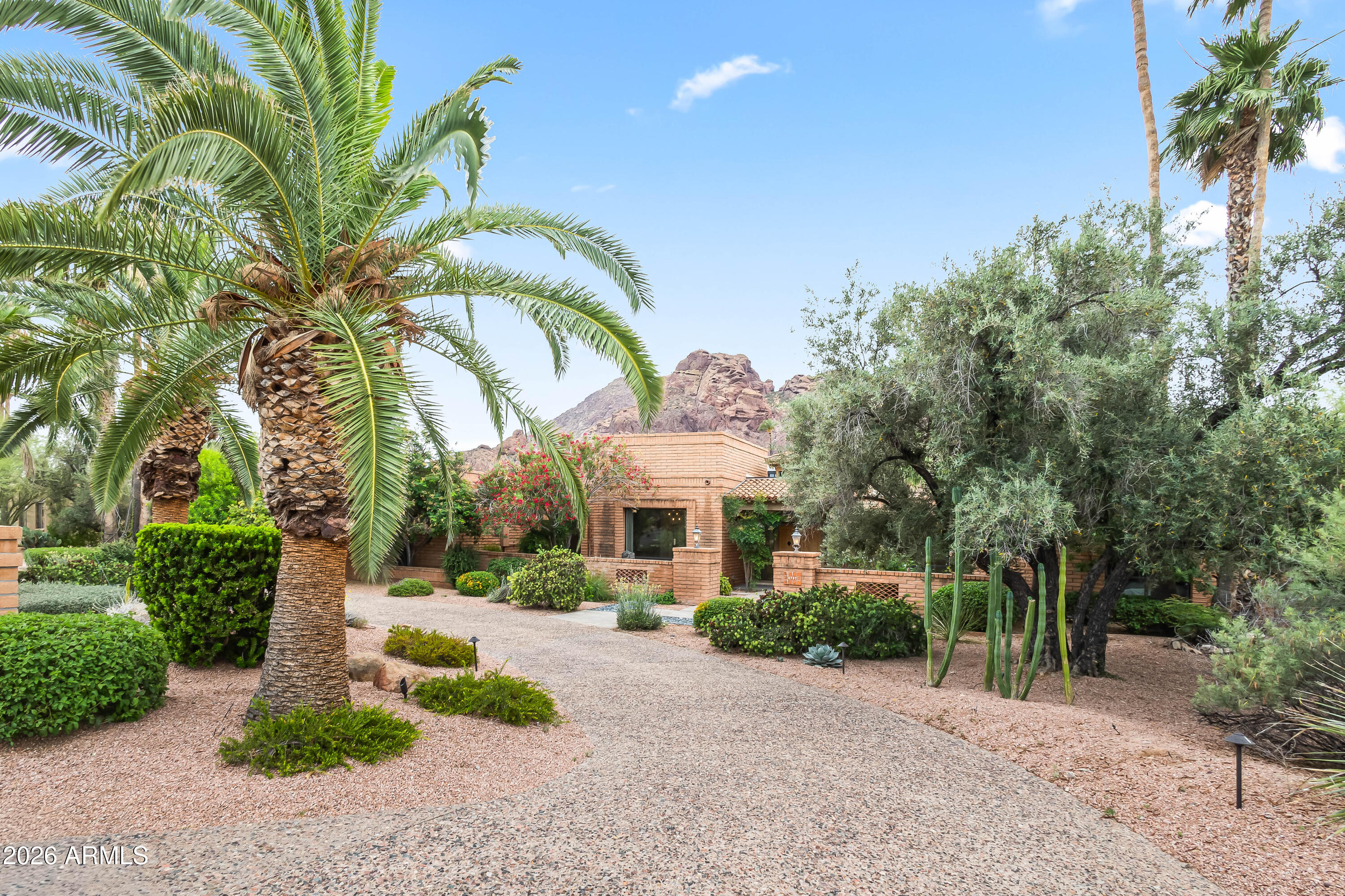 Nestled in the heart of Paradise Valley, this exceptional 6-bed, 5-bath estate with a detached casita and dedicated office spans nearly 4,500 sq ft of living space, offering breathtaking views of Camelback and Mummy Mountain from nearly every room. Ideally located just steps from the Echo Canyon Trailhead and minutes from upscale dining and luxury shopping in Arcadia and Old Town Scottsdale, the home delivers an unmatched blend of privacy, natural beauty, and convenience. Upon entry, soaring ceilings with rich wood paneling and skylights create a warm yet dramatic first impression. Thoughtfully curated details-exposed brick accents, custom paneled ceilings, designer wallpaper, and expansive windows-infuse the home with character and abundant natural light. The versatile floor plan features formal dining, multiple living spaces, and a billiard room, ideal for both entertaining and everyday living. The family room serves as the heart of the home, complete with a gas fireplace and wet bar for effortless hosting. The eat-in kitchen offers a cozy breakfast nook framed by stunning mountain views, creating a serene setting to begin and end each day. The spacious primary suite is a private retreat, featuring a sitting area, direct backyard access, dual vanities, a classic clawfoot tub, and an oversized walk-in shower. Outdoors, the resort-style backyard is designed for relaxation and entertaining, showcasing a heated pool and spa, built-in BBQ, lush grass area, and desert landscaping--all set against a dramatic mountain backdrop. Additional highlights include a two-car garage, two-car carport, and ample exterior parking.