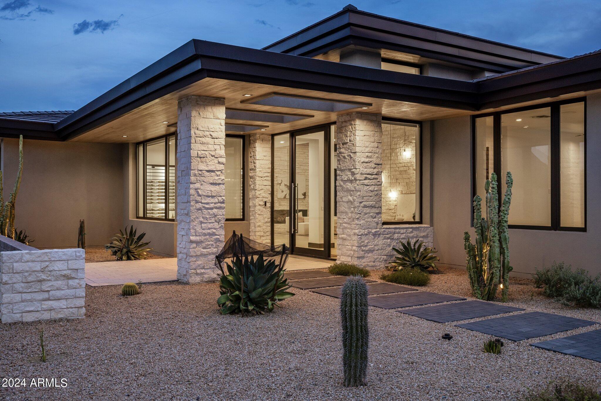 A New Construction contemporary masterpiece nestled within prestigious Solitude, North Scottsdale awaits the discerning buyer. Built in 2024 and spanning over 5500 square feet with a separate casita, this architectural beauty designed by Swaback Architects and built by Sonora West Development, blends seamlessly with the desert landscape offering clean lines and a sophisticated façade that captures your attention, promising a home that is as stunning inside as it is out. The modern minimalist, open concept interior welcomes you with soaring ceilings, oak wood floors, custom chandeliers and high-end finishes throughout with over $895k in upgrades. Smart Home technology ensures every detail of modern living is at your fingertips, with an integrated audio visual system. More... A custom 490-bottle wine wall adds a touch of elegance in the entry and dining space of the home.  The retractable doors leading to the exterior living space with a South facing backyard, mountain views.  Enjoy the chilly Arizona evening with the in ceiling heaters and entertain with al fresco dining with a custom built in bar b que.