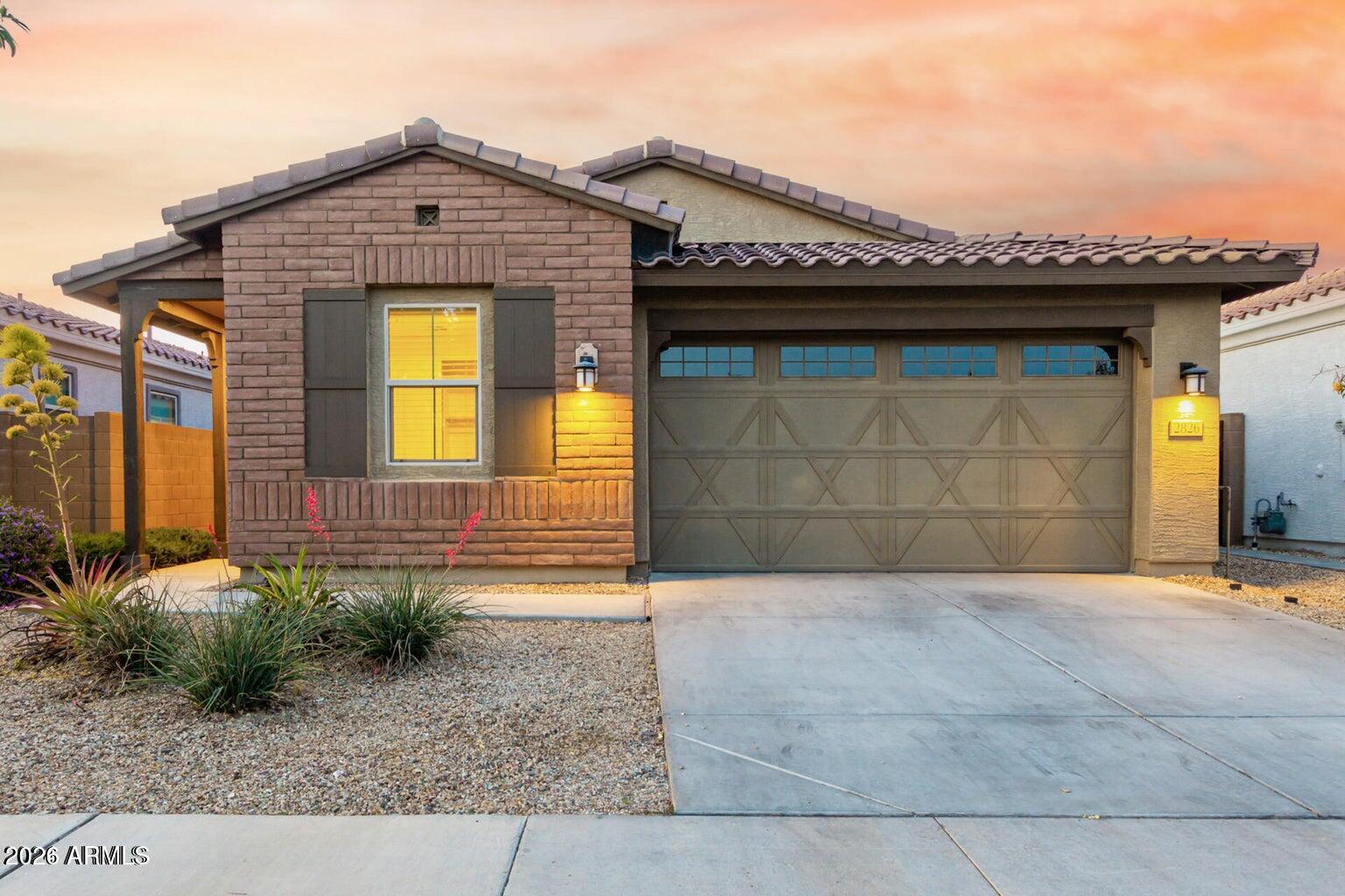 Welcome to this beautifully maintained 4-bedroom, 2-bath home in the gated Southern Enclave community! Built in 2018, this move-in ready home features a bright open-concept floor plan with abundant natural light, oversized sliding glass doors, and durable laminate flooring throughout. The kitchen offers granite countertops, a breakfast bar, pantry, and flows seamlessly into the living and dining areas--perfect for everyday living and entertaining. The spacious primary suite features dual sinks and a custom glass walk-in shower. Step outside to a covered patio and a low-maintenance backyard with premium turf. Enjoy the privacy and convenience of a gated community with five private parks, all just minutes from Downtown Phoenix, Sky Harbor Airport, shopping, dining, and major freeways.