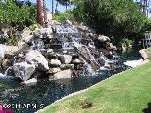 Prestigious, New and highly upgraded stunning home on the water in a gated community. Tropical Resort Living. Picturesque Waterfall Backyard. Imagine the soothing sound of the waterfall! Fresh paint, new flooring, new cabinets, quartz countertops new tile  in both bathrooms, Vaulted ceilings,  Surround Speakers! Ceiling Fans! 2x6 Sturdy Construction! Colonial Panel Doors! Fireplace Decorative Plant Shelves. ,Two Tone Paint,Elegant Wood Window Sills! Large Kitchen! Cabinets! Kitchen Island!  Split Plan. Very Private. Newer AC unit. Lovely Home! Landscaping included. Stunning community pool on the lake. Close to shopping and easy freeway access