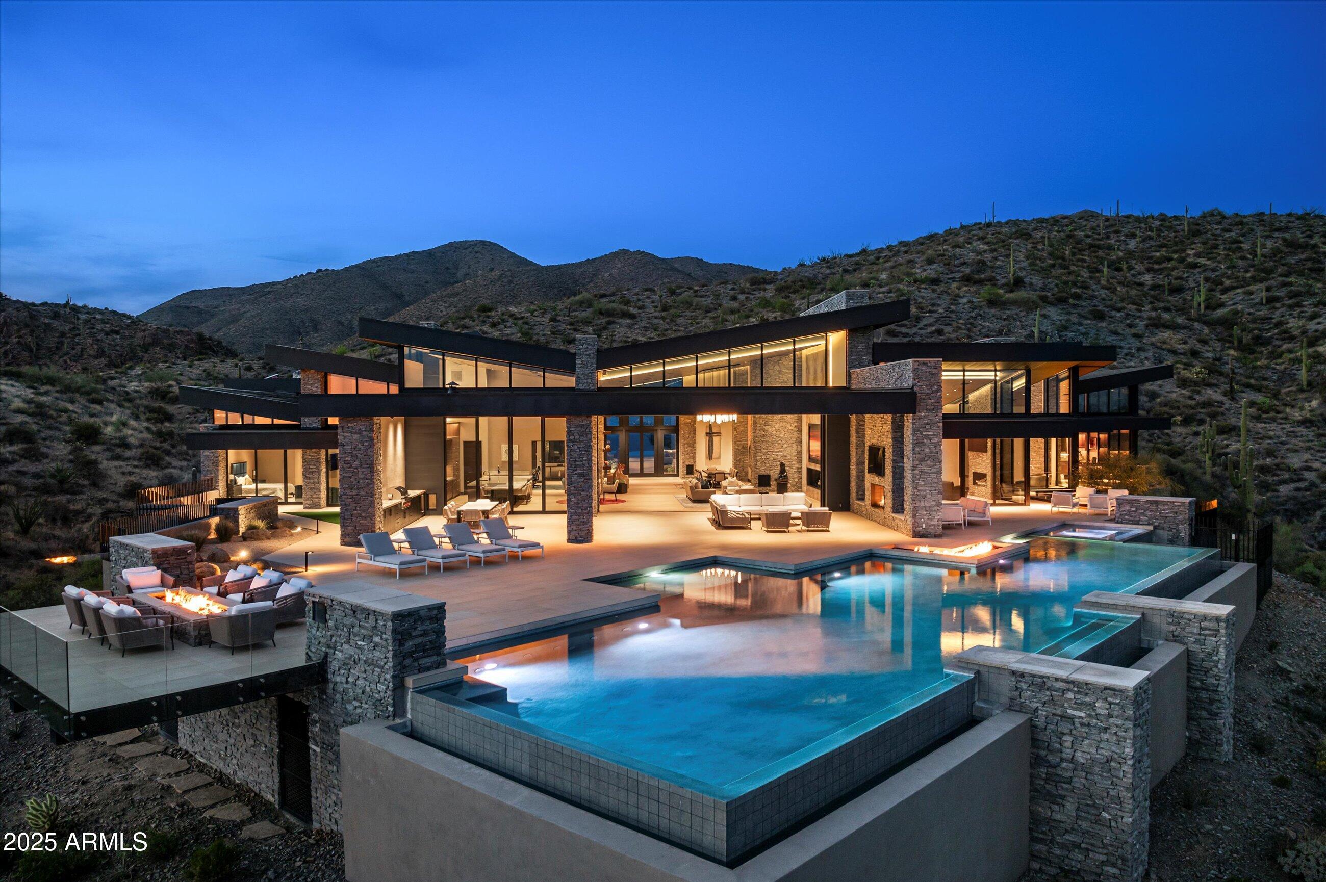 Golf Membership available from seller.  One of a kind Contemporary estate located in the world class community of Desert Mountain in North Scottsdale, Arizona. Designed and built by one of the top design build firms-JK Properties-Justin Kilbane. Situated on 4.7 acres at the top of the Desert Mountain community and overlooking the valley of the sun, this setting is arguably one of the best in all of North Scottsdale. With 3,000 acres of open space that parallels the home as well as the Tonto National Forest just to the north, this extremely private setting is unmatched. As you enter the private gated driveway, you will be awed by the striking design of this home. Once inside the one level open great room floor plan leads to an expansive outdoor living area complete with spectacular views in every direction. Enjoy the

dual sided fire feature as you take in the panoramic desert and mountain views. The seamless connection between the indoor and outdoor spaces allows for the perfect environment to entertain guests or unwind in solitude. The design incorporates floor-to-ceiling glass walls that flood the space with natural light, while also offering unparalleled privacy.

The home boasts high-end finishes and state-of-the-art appliances throughout. The gourmet kitchen is equipped with top-of-the-line appliances, a large center island, and custom cabinetry that perfectly complements the sleek design of the home. 
The primary suite is a private retreat, complete with a spa-like bathroom featuring a soaking tub, sauna, a spacious walk-in shower, outdoor shower with views of the mountains and dual vanities. In addition, the home also features four guest suites and beautiful study with dramatic mountain views. Two of the guest suites are located in the "in house" casita complete with sitting area, kitchenette and fireplace. 

Outside, the property continues to impress with its resort-style amenities, including a negative-edge pool, spa, outdoor kitchen, and ample lounging areas. The combination of luxury, modern design, and the unparalleled natural beauty of Desert Mountain make this estate an extraordinary living experience.

With access to the world-renowned Desert Mountain Golf Club, fine dining, and a variety of outdoor activities, this estate offers the perfect balance of tranquility, beautiful design and high-end living. Whether you're seeking a private retreat or a space to host guests, this home offers the best of both worlds.

This home sits on two lots that were combined into one homesite. There is ample space left to add an additional structure if one would choose to do so. Justin Kilbane is available to discuss design options for additional garage and structure space.

Lot 357A-9607 E Cintarosa Pass, Scottsdale , AZ 85262, the lot next door is available from the seller for $2,750,000 with a Lifestyle Membership available from seller.

Home is being offered furnished with several exceptions. Also, the only art that would convey would be two pieces - the large piece in the dining room as well as the large piece in the "in house" casita.