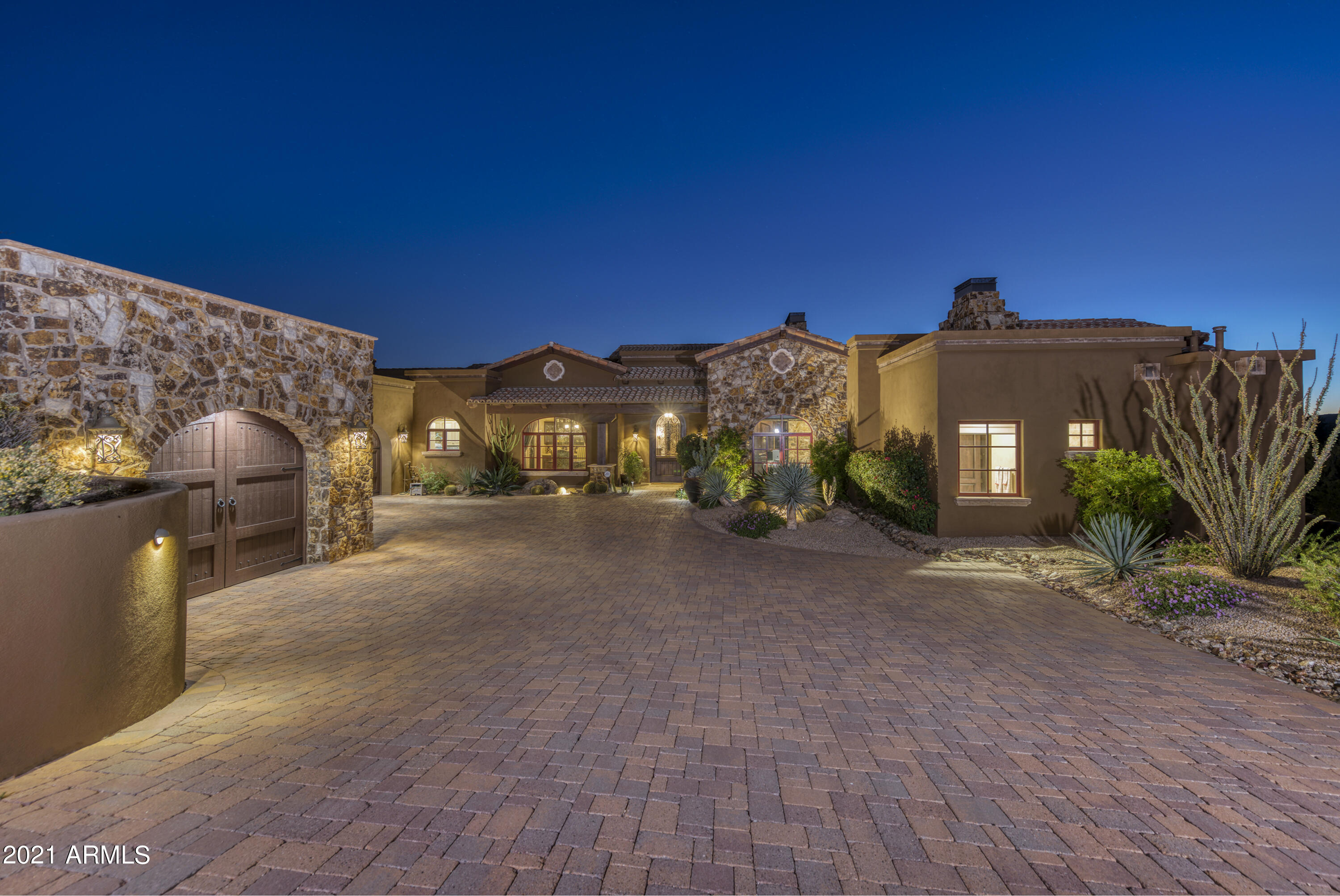 Take a step into this custom Mediterranean style home in the Village of Lost Star. Designed by award winning architect, James Hann & built in 2013 by Augusta Homes. This warm, sophisticated home boasts expansive vaulted ceilings w/ exposed beams & natural stone accents inside/out. Relax or entertain while overlooking stunning city light &  mountain views from this tranquil desert oasis. Casual, open-living great room design. This home features both Master & Junior suites, along w/ 2 en-suite bedrooms in a split floorplan. Spacious Chef's kitchen w/ double island & wolf/subzero appls. Bonus features incl a built in office, wine cellar, wet bar, game room, exercise room, grand pantry, & oversized 3 car garage. Resort style outdoor living spaces w/private patios, pool/spa, bbq & cozy firepit! Membership to the Desert Mountain Club is available by application.