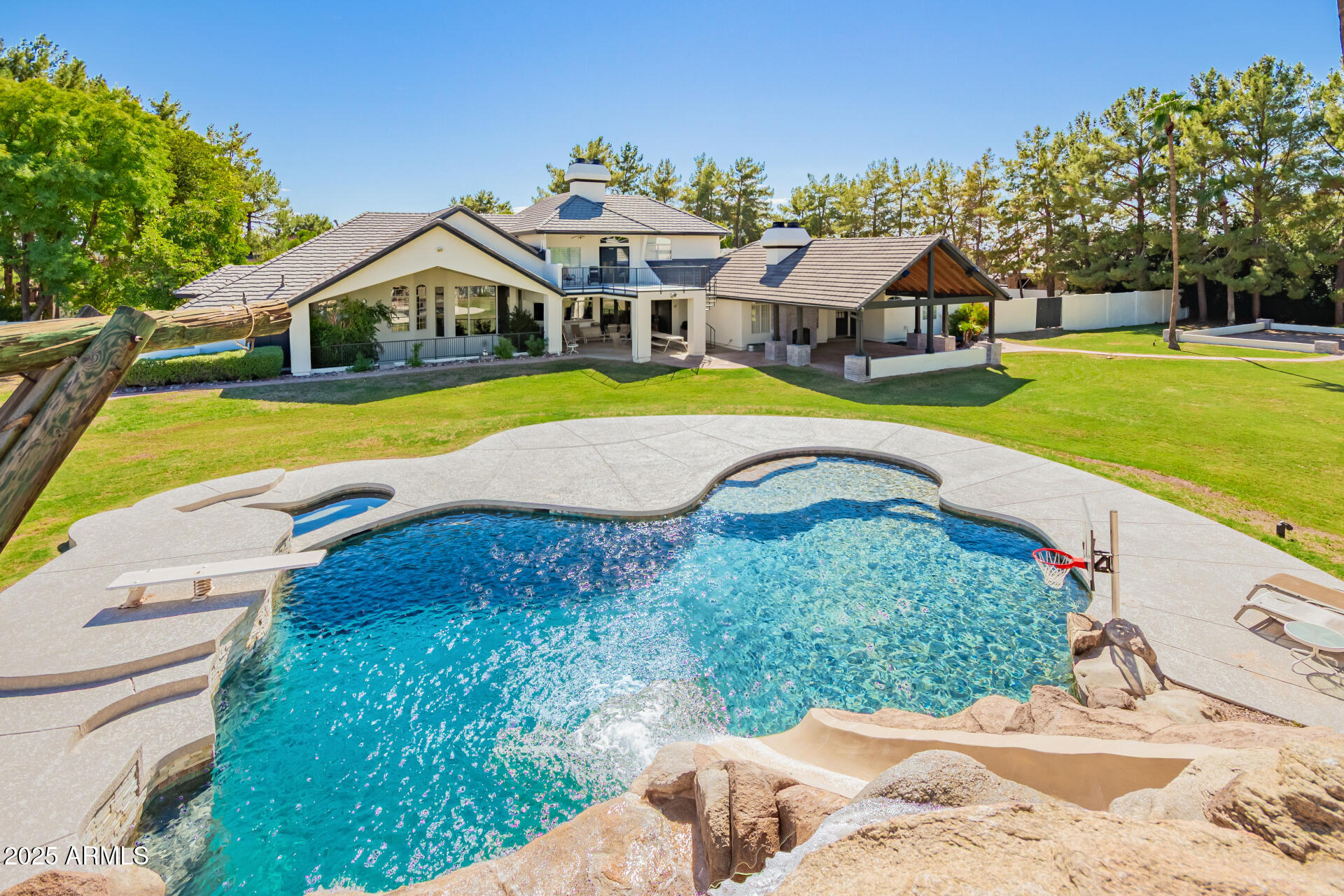 Welcome to 2350 N. Hall Circle, a stunning 7-bedroom, 7 bathroom estate in Mesa's sought-after 85203 neighborhood.  Spanning an impressive 8,338 square feet on a sprawling 3-acre lot*, this enormous residence offers unparalleled space and endless opportunities for family living and entertaining.  
Built in 1995, this expansive estate offers immense potential for those with a vision to renovate and personalize a grand property in a prime location.

*There are 2 parcels for sale in this transaction.
 Parcel # 136-06-005-J
Parcel # 136-06-005-V

Total acreage: 2.044 + 0.886 = 2.93 acres