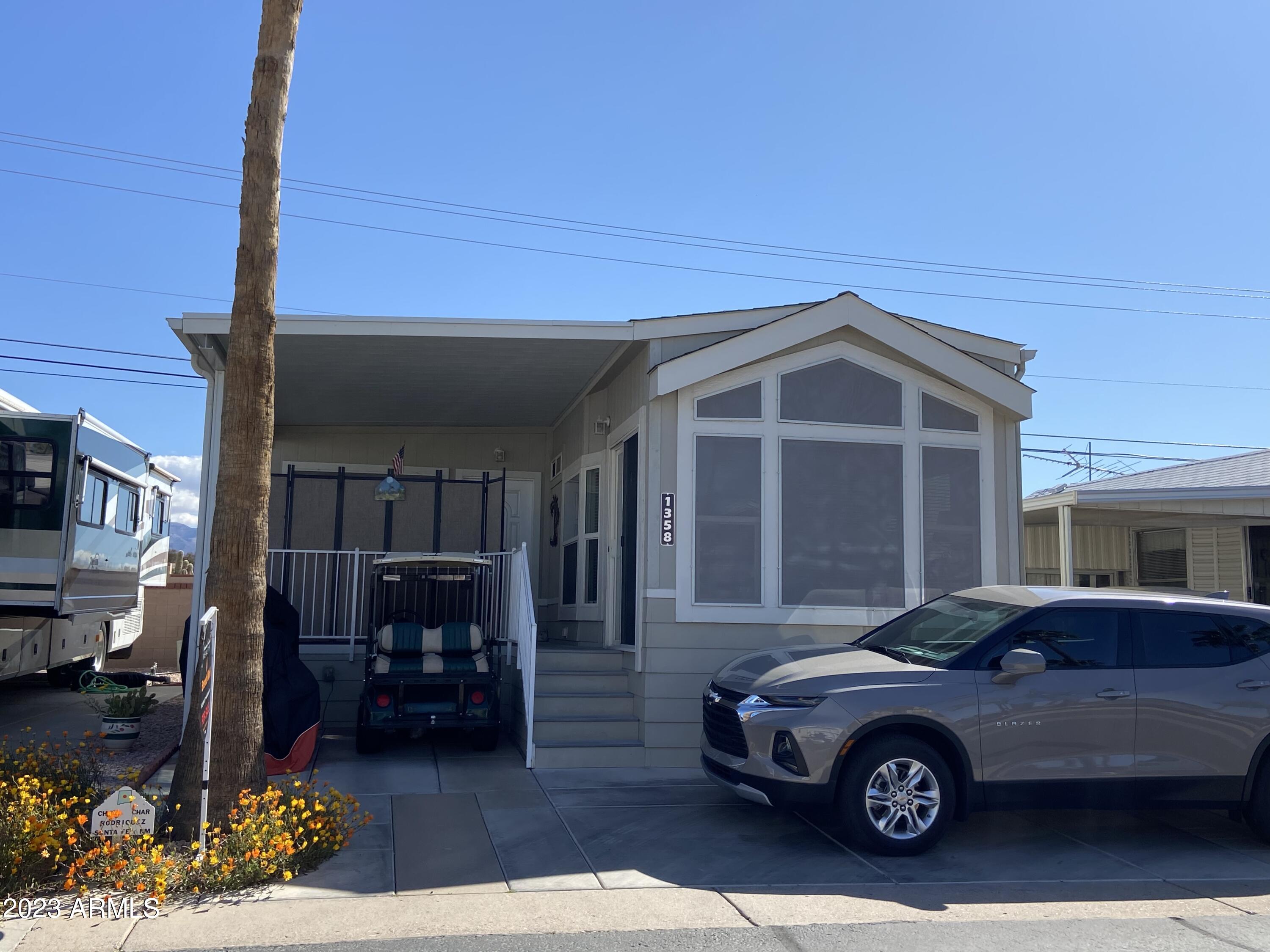 The perfect 55+ golf course resort where you own the land! Well maintained and ready for you to enjoy sunny Arizona this winter! Built in 2012 and set in 2014 this home is quality built. All on one level with Arizona room and extra bathroom. NEW AC/HEAT. Covered deck, solid surface flooring throughout, tall ceilings, light and bright interior. Two entry doors make the Arizona addition a perfect conversion to a two bedroom when you have visitors! Convenient inside laundry, whole home water filtration system, full size appliances. This unit comes fully furnished.
