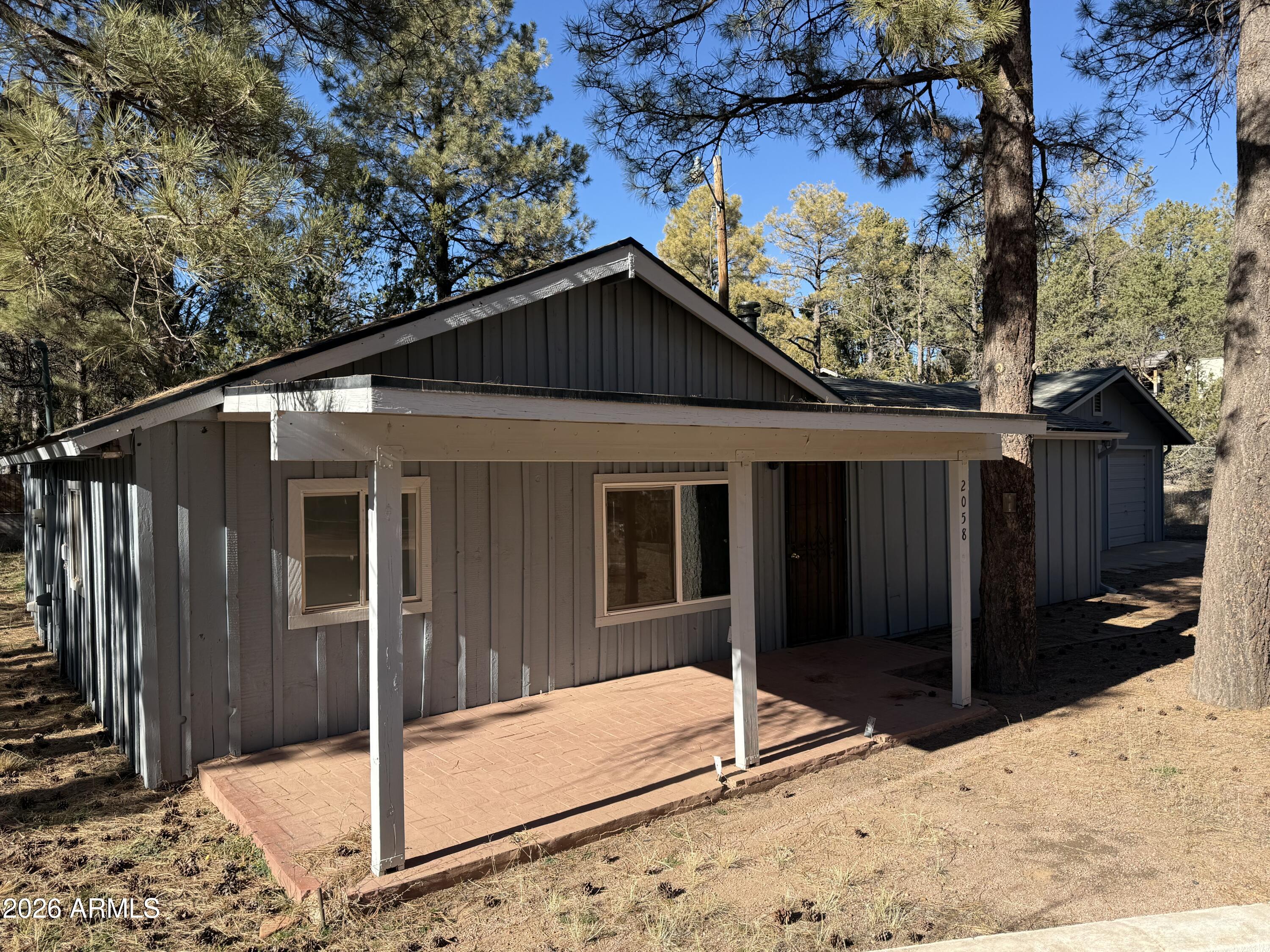 Escape to the cool pines of Overgaard with this charming 3-bedroom, 2-bathroom home on over 1/3 acre. Featuring fresh interior paint, a spacious kitchen with modern amenities, a 2-car detached garage, and a large, fenced dog run, this property is perfect for a mountain retreat. Enjoy the serene, tree-covered surroundings. 
Property Highlights for 2058 Pine Haven Ln:
 • Cozy Living: 3-bed, 2-bath single-story home (approx. 1,100 sq ft) built in 1971.
 • Mountain Setting: Situated on a 0.34-acre lot surrounded by mature Ponderosa pines in the Holiday Forest area.
 • Upgraded Kitchen: Features ample storage, upgraded countertops, and a stainless steel refrigerator.
 • Outdoor Living & Amenities: Covered front patio, fenced dog run, and a 2-car detached garage.
 SEE MORE " Upgrades: Fresh interior paint and a front security screen door.
 " Utilities: Septic system, bottled gas, and Navopache electric.
 " No HOA: Enjoy freedom in this quiet neighborhood
***HOME WARRANTY INCLUDED WITH ACCEPTABLE OFFER***