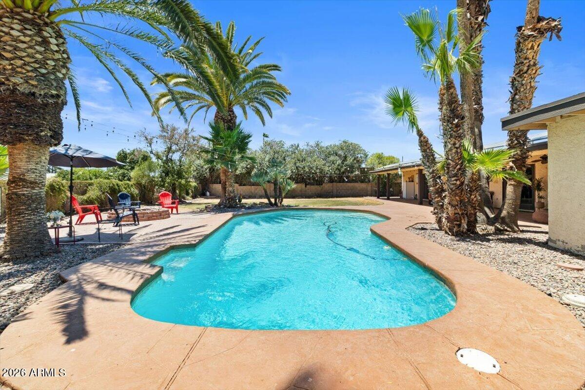 SOLAR + NEW HVAC-- a $200+ savings/summer month on average! This remodeled 3-bedroom, 2.5-bath single-story home offers a rare combination of comfort and convenience-- including a NEW VARIABLE SPEED POOL PUMP, VAULTED CEILINGS, 2-CAR GARAGE with STORAGE, RV Parking, & NO HOA-- with the value trifecta of the ''MAGIC ZIP CODE''-- a Scottsdale address, lower-priced Phoenix utilities/taxes, and Paradise Valley's world-class school district. Experience an open, sun-drenched layout with fresh neutral tones, tile flooring and LED lighting throughout, and a primary suite featuring his-and-hers closets, dual vanity, a Roman tub! The inviting living space features vaulted ceilings with exposed beams, a spacious great room with a fireplace, and an eat-in kitchen, featuring a large kitchen island, ample counter space, premium appliances, and French doors to the private backyard and sparkling diving pool.

The west wing offers a value-add potential for an ADU or flex/guest suite conversion (half bath adjacent to the RV gate--buyer to verify permitting). Centrally located between Loop 101 and Route 51 freeways, residents commute anywhere in the valley quickly: Nightlife in Old Town Scottsdale, dining and shopping at Kierland Commons and Scottsdale Quarter, the Waste Management Phoenix Open at TPC Scottsdale, the Arabian Horse Show, and the Barrett-Jackson Collector Car Auction at WestWorld. These events draw visitors from around the globe, creating lucrative short-term rental opportunities for homeowners and investors looking to capitalize on the area's growing popularity.

With all major systems serviced, it's move-in ready and energy-efficient for the hot Scottsdale summers. With no HOA, this home provides both privacy and freedom in the tranquil Paradise Valley Village neighborhood. Don't miss this exceptional opportunity. Discover your peaceful retreat-- your new home awaits!