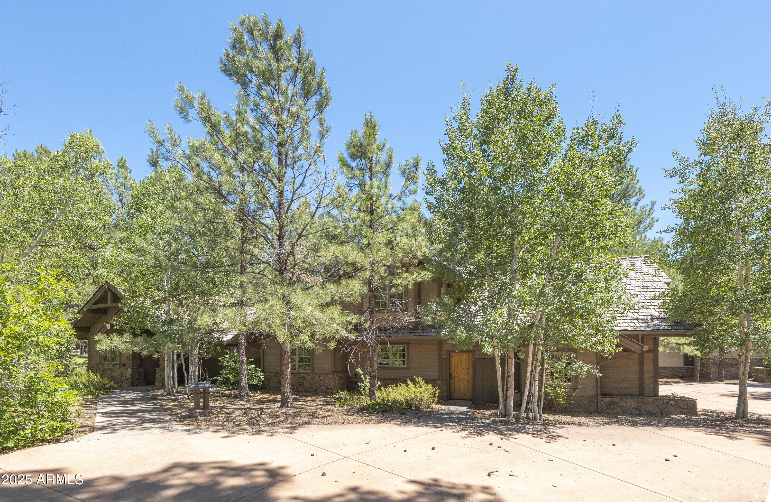 Tucked back in the back of this .97 acre lot, this home is private with golf course views from behind the 12th tee box of the Meadow Golf Course.  The long, circular drive as you approach sets the stage.  Enter into a large great room with cathedral ceilings and stone fireplace and direct, open access to the chef's kitchen.  The main level master suite and additional guest suite provide comfort for guests.  All bedroom are large and are en-suite.  An additional bonus room upstairs offers nice separation for additional entertaining or a place for the kids to escape.  The outdoor space provides both covered and uncovered deck, large firepit, built-in BBQ and large spa.  Top it off with a 3 car garage and central air conditioning and you've got the perfect Paradise in the Pines retreat!
