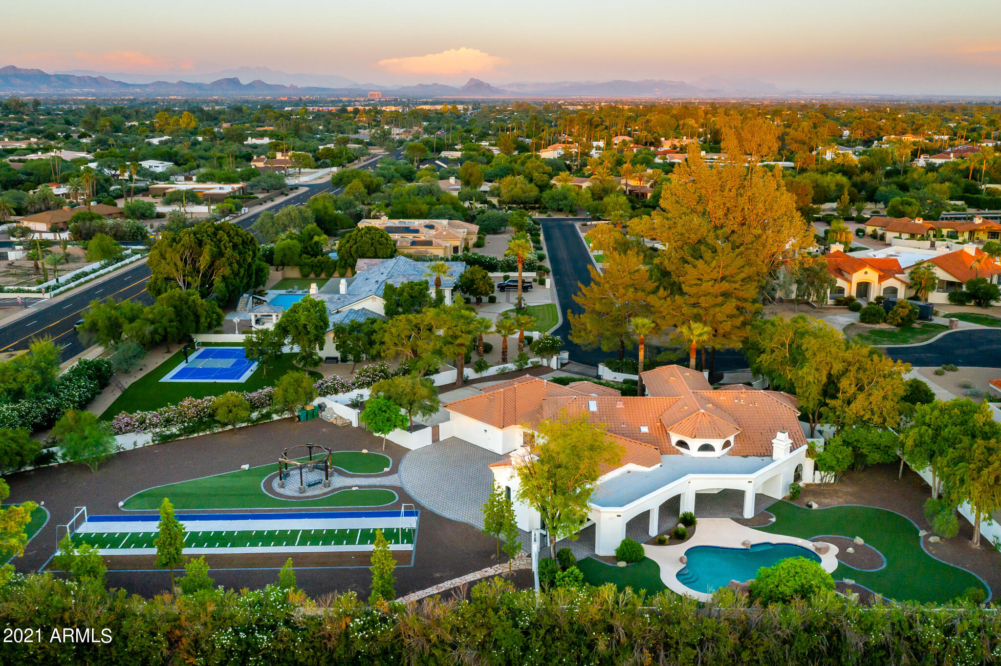Renovated with architectural strength and highly customized French/Spanish elements.  This richly appointed double gated residence with superior views of Camelback and Mummy Mountain is impressive.  Appreciate aesthetic effects of hand formed cedar plank ceilings, massive ironwork entry doors, raised interior doorways, lighted coved niches, ironwork chandeliers, herringbone floors, added view windows, copper tub, cantera stone baseboards, trim and FPs, fully redone kitchen and baths, zinc high ceiling kitchen range hood and gleaming double oven gas range for a banquet.  Enjoy heated slide pool, rock waterfalls, multiple paver courtyards, synthetic turf, and practice soccer field.  Stargaze in open sky gazebo with conversation swings. Listen to nearby soothing Casa bells.  Exceptional home. Property has both Camelback & Mummy Mountain expansive views in the most desirable quadrant of Paradise Valley.  Plenty of room on this lot to build a guest casita and/or extra garage space. Garage is ready for Electric/Tesla cars charging.  Home has been re-plumbed with Flex plumbing,  Salt water system for heated pool.