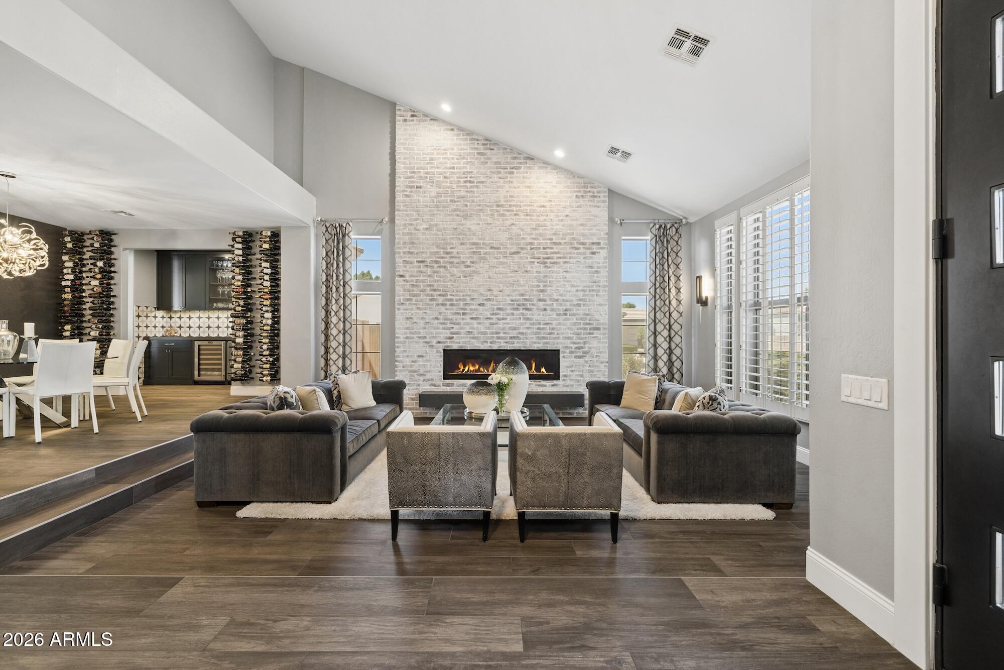 Exceptional entertainer's residence offering seamless indoor-outdoor living, thoughtfully designed and professionally curated. The chef's kitchen features custom Burdette cabinetry, a Thermador 6-burner gas range with griddle and dual ovens, and a striking artistic statement hood. Designed for effortless hosting with three dishwashers, filtered water at kitchen and bar sinks, expansive pantry space, and an updated bar with ice maker, wine, and beverage refrigeration. Designer lighting on dimmers creates a warm, sophisticated ambiance. Fully reimagined by an interior designer, the home blends elevated style with everyday livability. The resort-style backyard showcases an extended covered patio, built-in BBQ, custom fire feature, integrated surround sound, and a dedicated pool bath. The primary suite offers a spa-inspired retreat with a full steam room integrated into the shower.