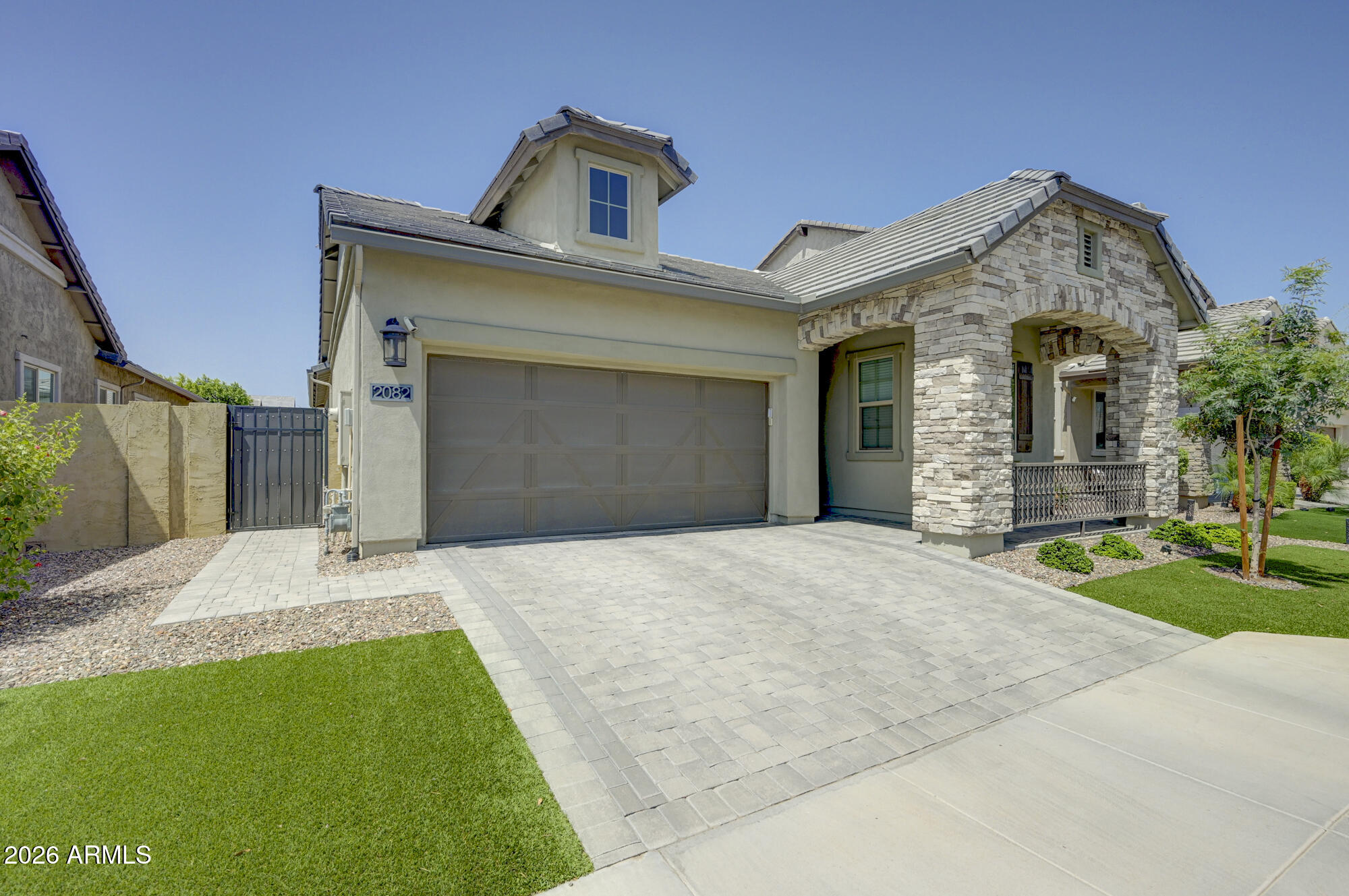 This home shows like a model! Beautifully maintained and thoughtfully upgraded, this exceptional home is located in Stratford, a desirable gated Gilbert community and offers the perfect blend of style, comfort, and functionality. The open-concept floor plan features spacious living areas filled with natural light and a beautifully appointed kitchen showcasing upgraded backsplash, designer hardware, ample cabinetry, generous counter space, and a large island overlooking the great room--perfect for everyday living and entertaining. Large wood-look tile flooring and neutral automatic blinds add a modern, elegant touch throughout the home. The spacious primary suite offers a relaxing retreat with an ensuite separate shower and large soaking tub and walk-in closet, while the additional bedrooms provide flexibility for family, guests, a home office or hobbies. Enjoy added convenience with a video doorbell, owned reverse osmosis system, owned water softener, and an oversized 3-car tandem garage with plenty of room for vehicles, storage, or a workshop. Step outside to a low-maintenance backyard featuring lush turf, creating the perfect space to relax, entertain, or enjoy Arizona's beautiful weather year-round. Residents enjoy the benefits of a gated community complete with a neighborhood park and playground, all while being conveniently located near shopping, dining, parks, top-rated schools, and major commuter routes. This move-in-ready home truly has it all! Make it yours before it's gone!