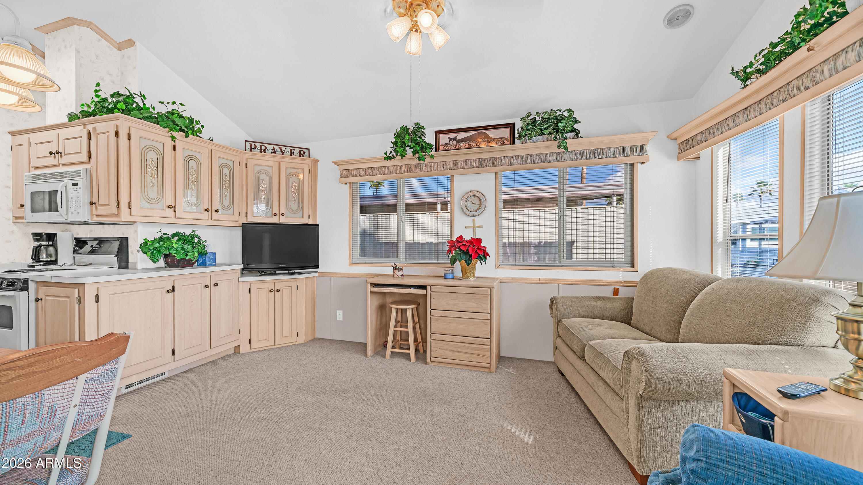 Bring your pets & step into your own slice of Arizona sunshine in the desirable pet section of Golden Vista where you own the land & the lifestyle. As you arrive you are welcomed by an impressive L shaped deck that immediately steals the show, offering generous outdoor living space & breathtaking Superstition Mountain views, the perfect place to sip your morning coffee or host friends while enjoying the warm winter air. Inside you will find a bright open living area with tape & textured drywall that adds a finished feel & comfortable charm. The kitchen is filled with natural light from an overhead skylight, creating a cheerful space to cook & gather. The bedroom offers thoughtful storage with two mirrored closets, a built in dresser, & a convenient lift & store bed that maximizes space. The bathroom is spacious with a tub shower combination & dedicated linen storage for added convenience. Step outside to the paver back patio for even more room to relax, while beneath the deck you will find built in storage drawers that make organization easy. A well equipped workshop shed houses a full size washer & dryer, water heater, & shelving for projects or extra storage. Whether you are searching for a full time home, seasonal retreat, or easy lock & leave getaway, this inviting property places you in the heart of an active 55 plus resort community filled with amenities, activities, & endless opportunities to enjoy the Arizona lifestyle.