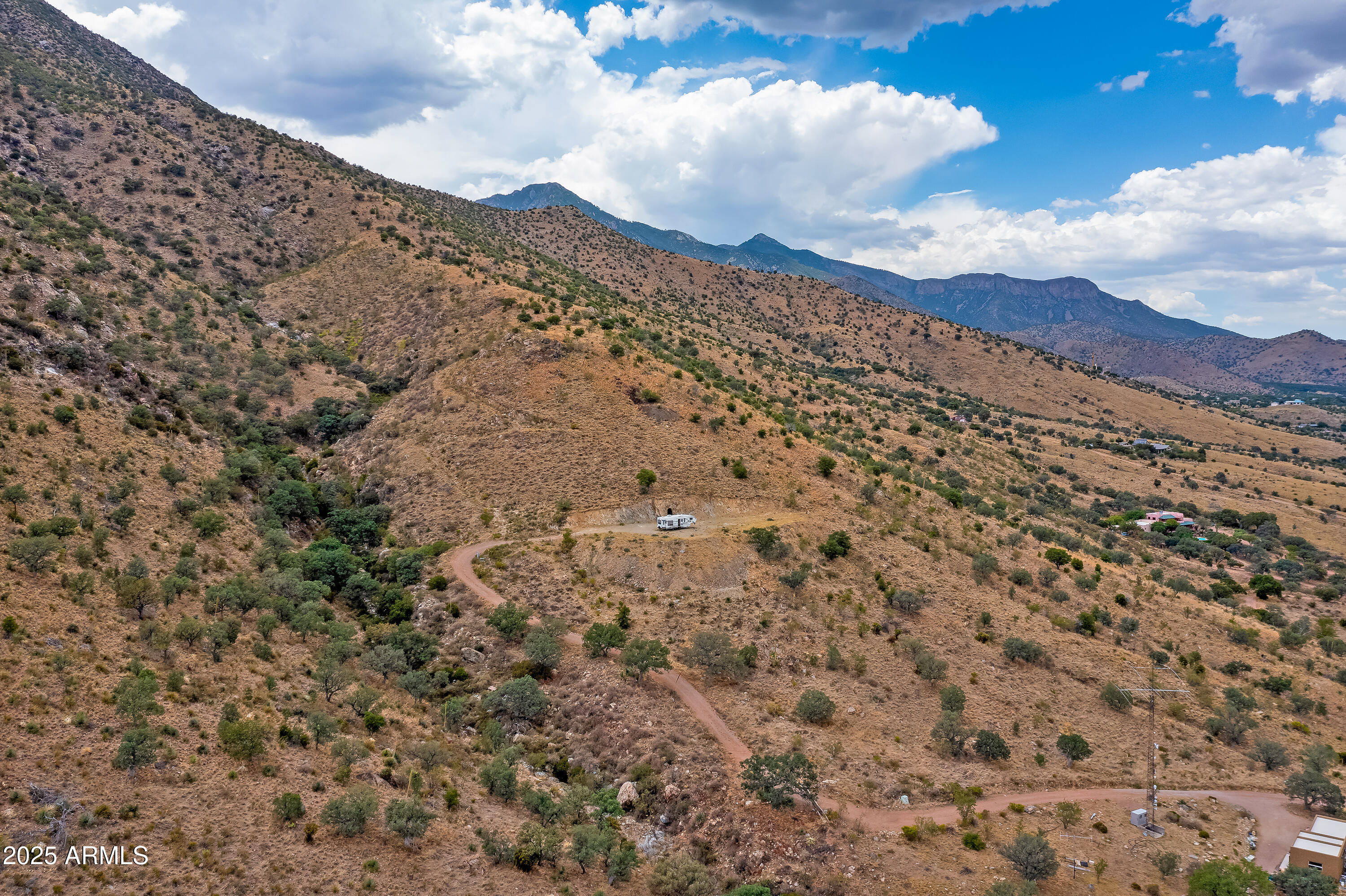Lower 5 acres, 1/3 well share and mine. Surrounded by national forest in the Huachuca Mountains; great hiking, camping and hunting; abundant wildlife; beautiful building site with awesome views, power and water; excellent access, just one mile off highway 92. Has a gated 250' lighted mine. Short distance to Ramsey Canyon, Coronado National Park, and Our Lady of the Sierras Shrine and Chapel. Easy drive to Bisbee, Tombstone and Sierra Vista. Tucson Airport just over one hour. Elevation 5, 230' for ideal climate. Owner will carry with 25% down.