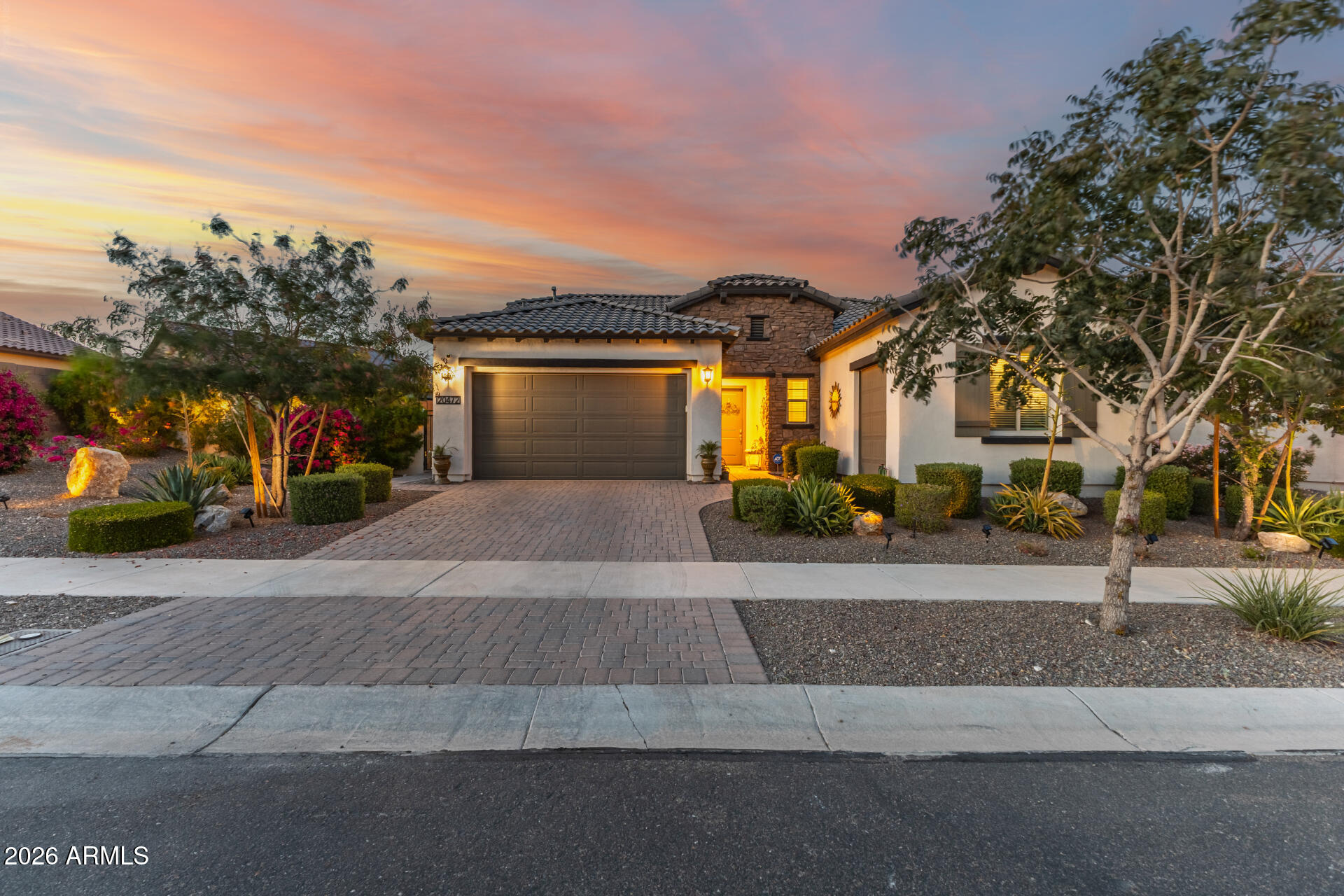 Resort-style living in Victory at Verrado 55+ Built in 2021, this single-level home offers 2,142 sq ft with 2 beds, 2.5 baths, and a versatile den with built-in desk and Murphy bed. Set on a 0.23-acre lot, it features a 2-car garage plus golf cart garage. Bright open layout with high ceilings and abundant natural light. Gourmet kitchen boasts a double oven, dramatic vaulted ceiling, upscale finishes, and seamless flow for entertaining. Backyard oasis with $150K+ in upgrades includes a heated pool with waterfall, travertine patio, mature landscaping, wood-burning fireplace, built-in BBQ, and gas fire pit--perfect for year-round Arizona living. Move-in ready! All furnishings available through separate bill of sale.