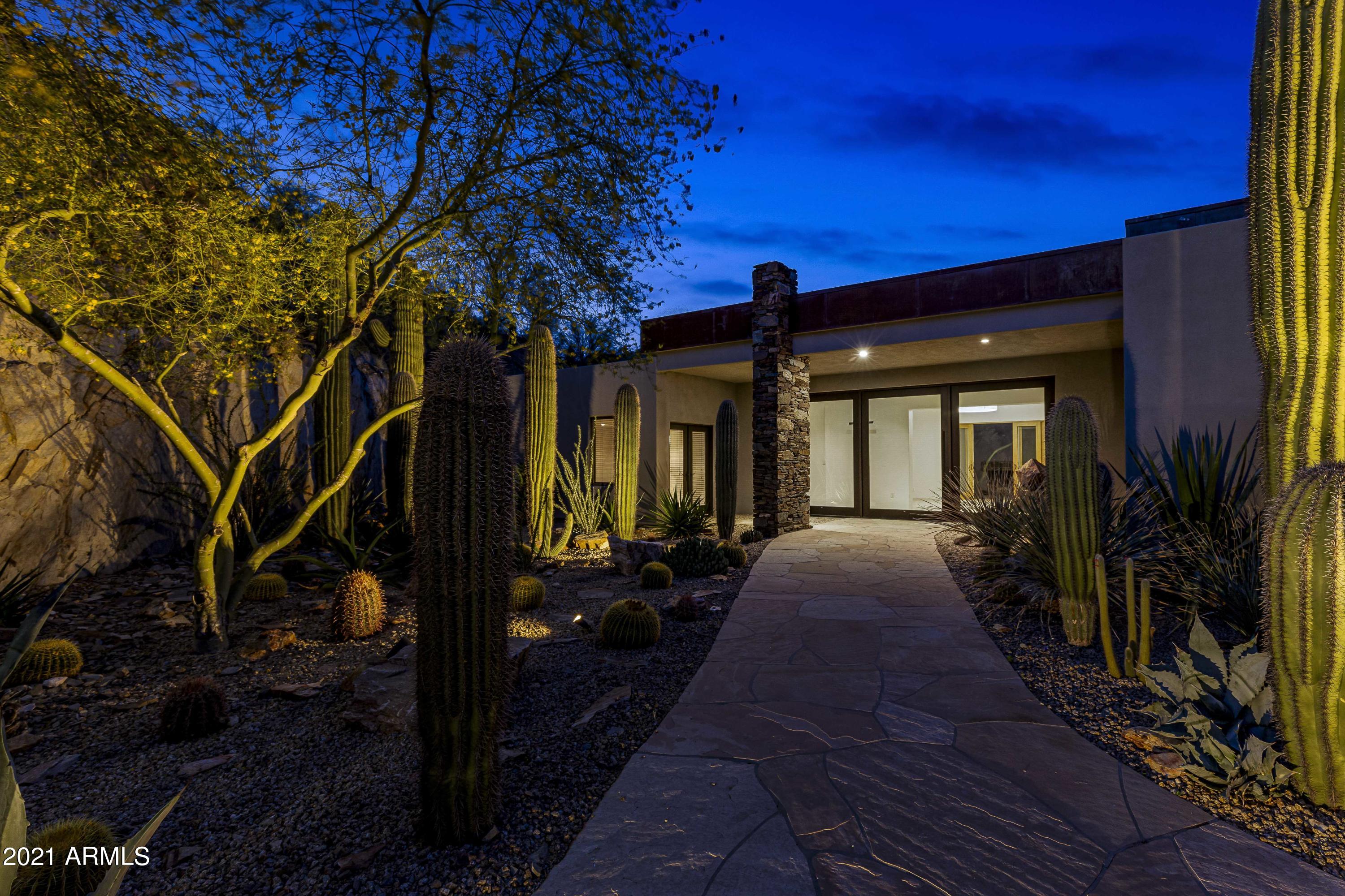 Perched on its own hilltop in the prestigious 24/7 gated community of Clearwater Hills, this single level, move-in ready, private entertainer's estate has clean lines and an elegant, modern style. The walls of windows allow the truly breathtaking mountain and city views to take center stage. The open, split floor plan offers seamless indoor/outdoor living and endless large scale entertaining opportunities. Each room of this spacious 4,829 SF 3 bedroom + office (optional 4th bedroom) 3.5 bath home is loaded with flawless, custom features, including custom lighting, plaster and bronze inlaid fireplace, full wet bar, art niches, custom built-ins and an atrium with a fountain and fireplace. Multiple, large covered patios and the sparkling pool with delightful water feature provide different vantage points and settings to entertain, enjoy the outdoors and gaze at the ever-changing panorama. Mature xeriscape makes this a wonderful lock and leave property or easy care family home. Bring your most discriminating buyers to see the stunning views from this extraordinary estate!