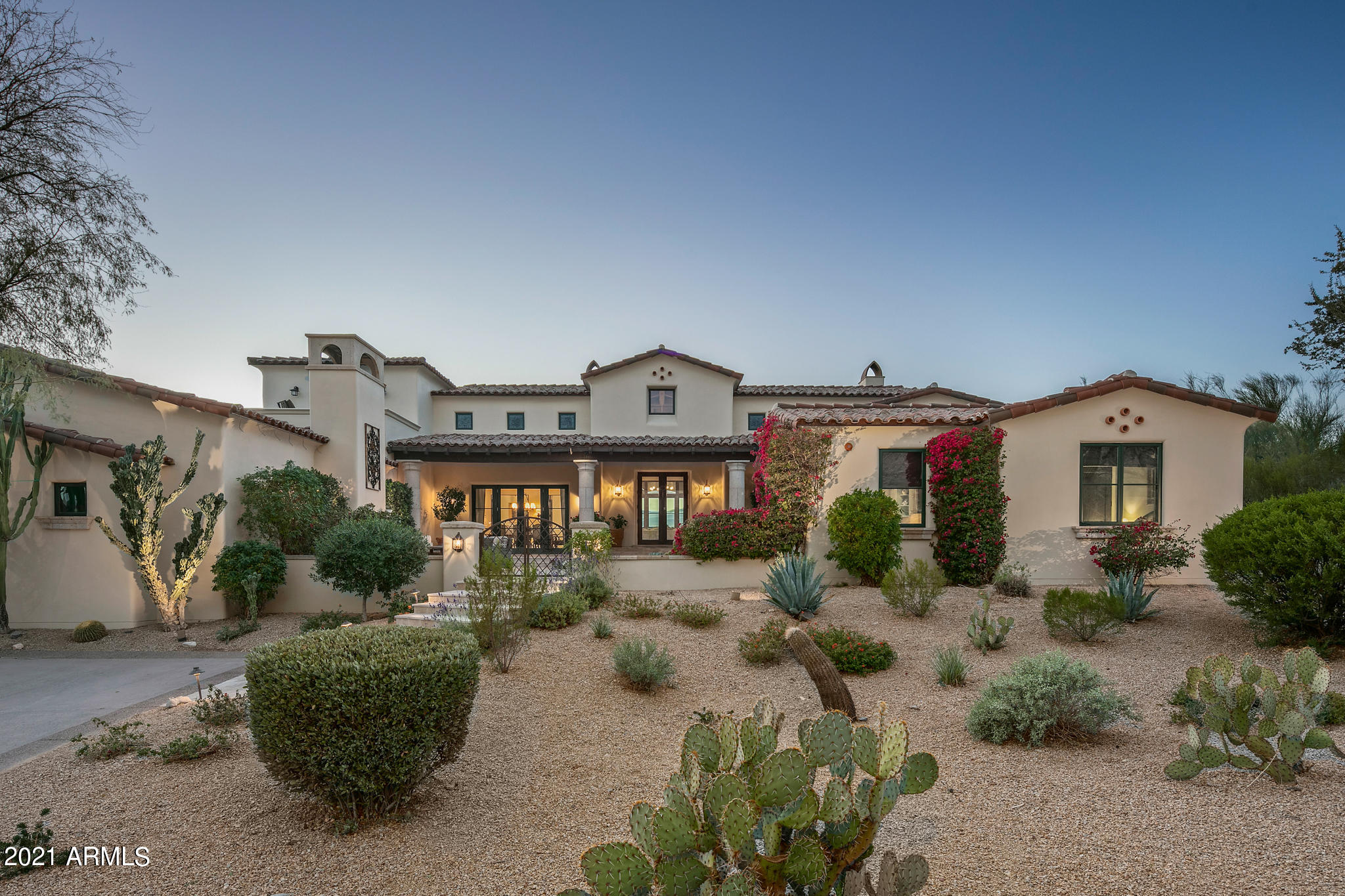 Premier location on a cul-de-sac in the gated community of the Country Club at DC Ranch. Single level living with fabulous floor plan. Every room is on the main floor except one guest bedroom and bath.  All new kitchen with every amenity. Outstanding outdoor living--diving pool, spa, 3 fireplaces, outdoor kitchen, superior landscape, VIEWS! Master retreat with charming patios is split from other bedrooms, features large spa-like bath and his/her closets. The guest wing has it's own bonus or game room and 3 bedroom suites, each with private bath and walk-in closet. Upstairs, 1 additional bed/bath suite with balcony. Private office  and home theatre/media room are added highlights. Separate guest house with living area, kitchenette, bedroom and bath and washer/dryer. Huge 4 car garage.
