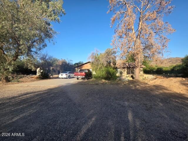 Over an acre of irrigated land with no HOA and Guest house. Mountain views all around. Minutes from 202 freeway. Extremely private location with city conveniences close by. Interior of home offers a split floor plan with separate living and family rooms and a wood burning fireplace. Large secondary bedrooms. Home has great bones and huge potential. Home not been updated recently and will need some cosmetic repairs. The home has been priced with those things in mind.