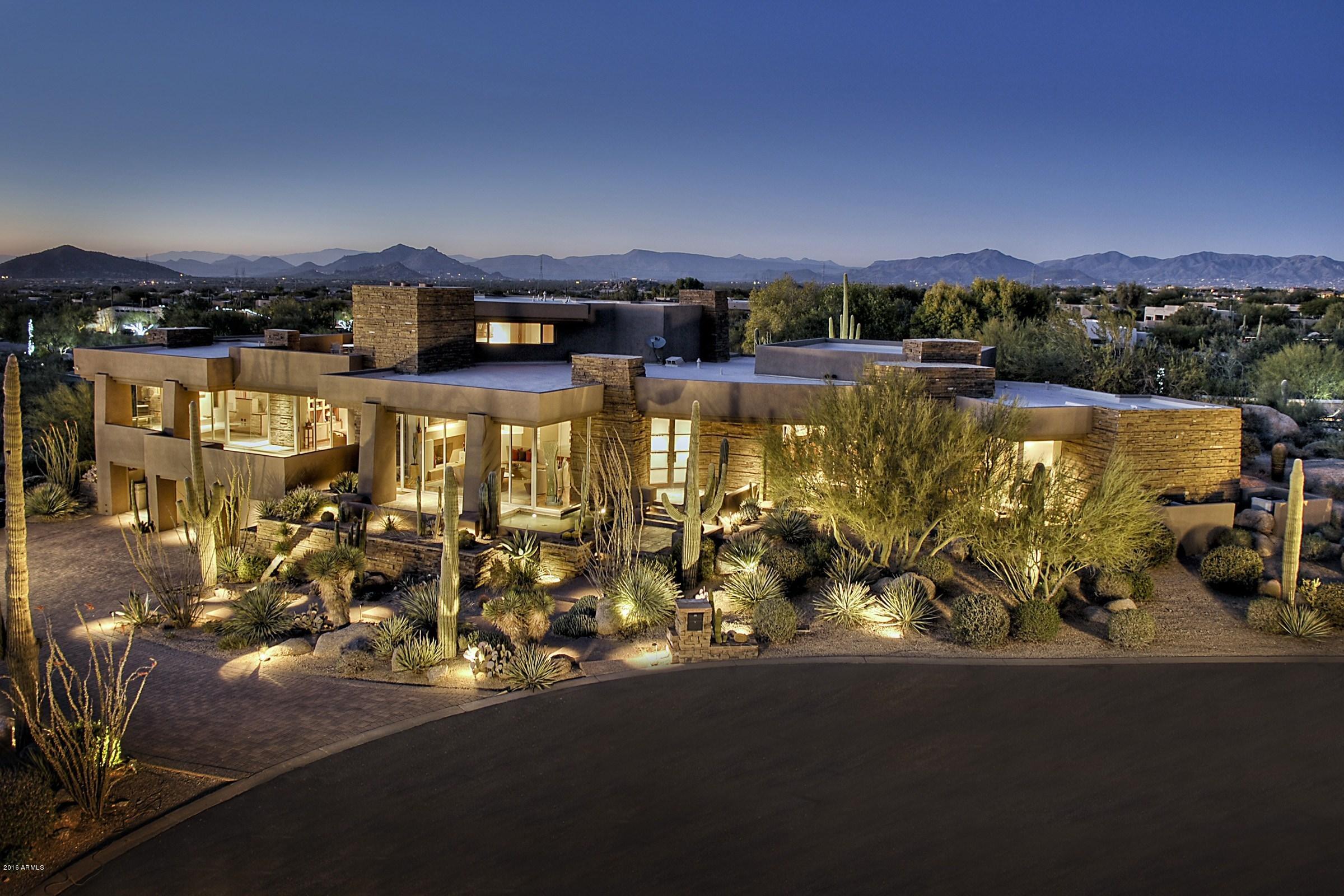 If you’re looking for a timeless custom contemporary home that showcases elegant, clean lines, grand flowing open spaces, a sophisticated interior color palette; a home that comes with majestic views, then look no further. Your privacy is protected by dramatic boulder outcroppings that form part of the unique landscaping. Barely lived in, this home shows like new and the floating spiral staircase is a wonder of architectural design, leading to the upper level media and games rooms. Or use the elevator if you prefer. Each bedroom has a large full bathroom en-suite and there are incomparable views from almost every angle, not least from the roof deck patio, where distant city lights, the exclusive Estancia golf course and famous Scottsdale sunsets will take your breath away.... An exclusive retreat for work, play or rest, this is the home you will probably never want to leave, and it will leave your guests in awe!
All professional interior design custom furnishings and accessories are available under a separate bill of sale.