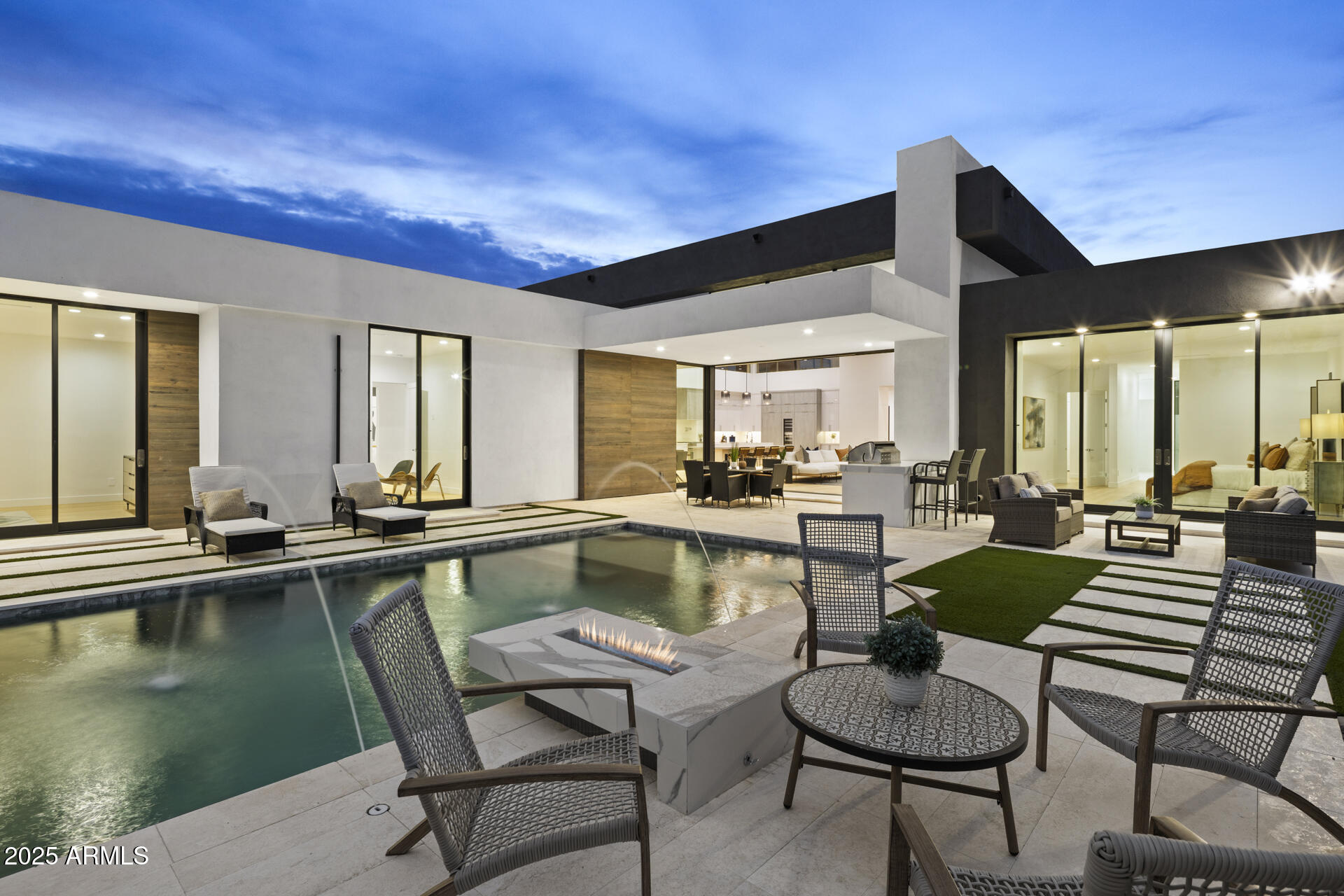 Stunning Modern New Build just completed in Paradise Valley.  Situated within walking distance to the finest shopping & dining at Fashion Square and Old Town Scottsdale or head West to the Camelback Mountain Cholla Trailhead for a hike.
This home features floor-to-ceiling windows that flood the interiors with natural light.  The heart of the open floor plan is the Great Room, with soaring 16 ft ceilings and a striking 100 inch linear fireplace.  A 10' x 17' tuck-away sliding glass door seamlessly extends the living space to the backyard embracing Arizona's indoor-outdoor lifestyle.  
The chef's kitchen is a statement in both form and function, complete with an oversized island and premium Thermador appliances, including 92 bottle wine refrigerator. The split primary suite is a true retreat with a spa-inspired bath and an expansive custom closet.  Each of the 3 additional spacious bedrooms offers a private en-suite bath and walk-in closet.
The resort style backyard is an entertainer's dream, featuring a sparkling pool, outdoor shower, built-in BBQ, fire pit, and a generous turf area with views of Camelback Mountain.
Ideal for year-round living or as a low-maintenance lock-and-leave retreat, this exceptional home embodies modern luxury in one of Arizona's most coveted locations.