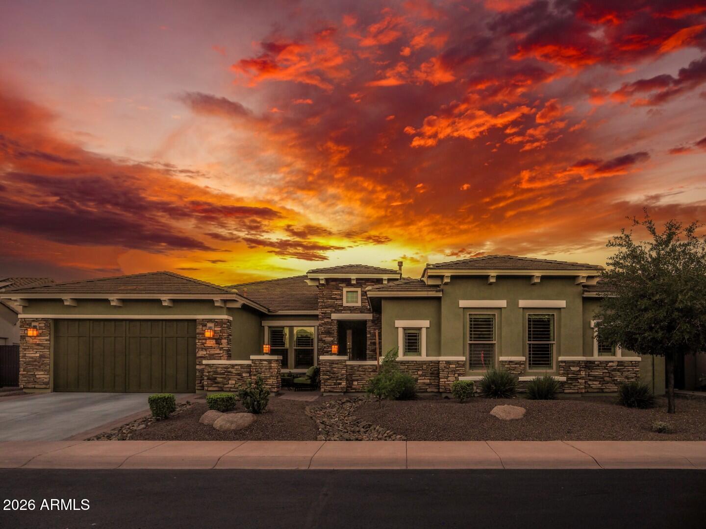 Assumable VA loan at just 2.375% is available to qualified buyers (not just veterans), offering potential savings of more than $1,200 per month compared to current market rates. Experience elevated desert luxury in the prestigious guard-gated community of Blackstone at Vistancia. Perfectly positioned North/South on a quiet street, this property combines luxury craftsmanship with outstanding energy efficiency. Designed with both comfort and entertaining in mind, the expansive open-concept floor plan showcases a stunning 16-foot sliding glass patio door for ideal inside/outside living. Thoughtfully designed for privacy and functionality, the home features four spacious bedrooms, each with its own private ensuite bathroom. The luxurious primary suite serves as a true retreat. In addition to the bedrooms, the home offers a large bonus room ideal for a media room, game room, fitness space, or secondary living area. A dedicated office provides the perfect work-from-home setup and could easily be transformed into a 5th bedroom if desired. The oversized pool anchors a backyard designed for entertaining and relaxation, featuring a built-in hot tub, gas fire pit, outdoor kitchen, and two rock waterfalls that create the perfect resort ambiance. Car enthusiasts and storage lovers will appreciate the oversized 4-car garage featuring polyaspartic-coated floors, full insulation, and mini-split A/C system for year-round comfort. With ample room for vehicles, toys, golf carts, and workshop space, the garage is as functional as it is impressive. Located within the exclusive Blackstone at Vistancia golf community, residents enjoy privacy, stunning mountain scenery, walking paths, and access to one of the Valley's premier luxury neighborhoods.