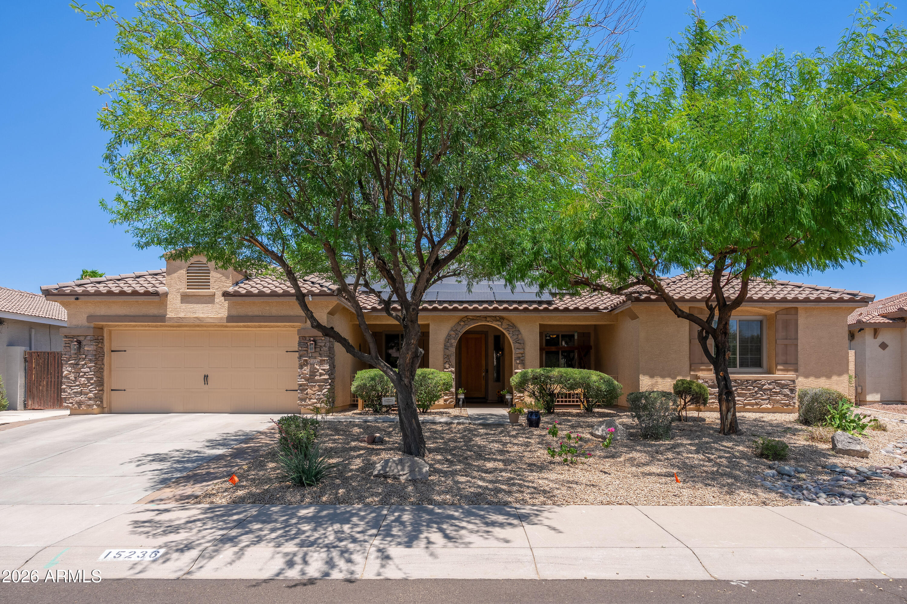 Rare opportunity to own a single-story home with over 3,100 sq ft in the highly desirable Palm Valley community of Goodyear. Situated on a 10,389 sq ft lot with no neighbors behind, this 4-bedroom, 3-bath home also features an enclosed den that can easily serve as a 5th bedroom, office, or flex space. Major upgrades include a new roof, paid-off solar, and new energy-efficient windows. The bright kitchen offers granite countertops, abundant cabinetry, and plenty of natural light. Hardwood and tile flooring run throughout much of the home. Enjoy Arizona living in the entertainer's backyard featuring turf, a fire pit, covered patio, and jacuzzi. Complete with a 3-car garage, built-in storage, and close proximity to parks, walking paths, schools, and the Goodyear Recreation Center. COME SEE!