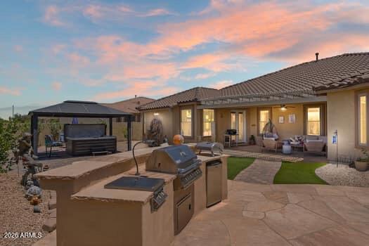 Rare opportunity to own a single-story home with over 3,100 sq ft in the highly desirable Palm Valley community of Goodyear. Situated on a 10,389 sq ft lot with no neighbors behind, this 4-bedroom, 3-bath home also features an enclosed den that can easily serve as a 5th bedroom, office, or flex space. Major upgrades include a new roof, paid-off solar, and new energy-efficient windows. The bright kitchen offers granite countertops, abundant cabinetry, and plenty of natural light. Hardwood and tile flooring run throughout much of the home. Enjoy Arizona living in the entertainer's backyard featuring turf, a fire pit, covered patio, and jacuzzi. Complete with a 3-car garage, built-in storage, and close proximity to parks, walking paths, schools, and the Goodyear Recreation Center. COME SEE!