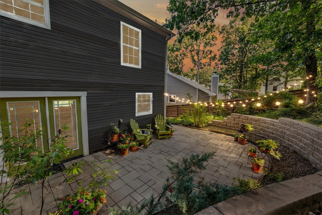 Nestled on a quiet cul-de-sac, this home captures the nostalgic charm of all-American living in a wonderful community. Beautiful stone and wood details frame a 2-car garage with a patio over looking you're private setting. Inside, you’ll find 5 bedrooms, including two that can serve as primary suites, and 3.5 baths. The updated kitchen with its open layout flows seamlessly into a cozy sunken living room, creating an inviting space for everyday living, while the backyard patio is perfect for entertaining or relaxing with your favorite book. Just 1 mile from top Fayetteville schools and a quick bike ride to Niokaska Creek Trail, this home offers both comfort and convenience