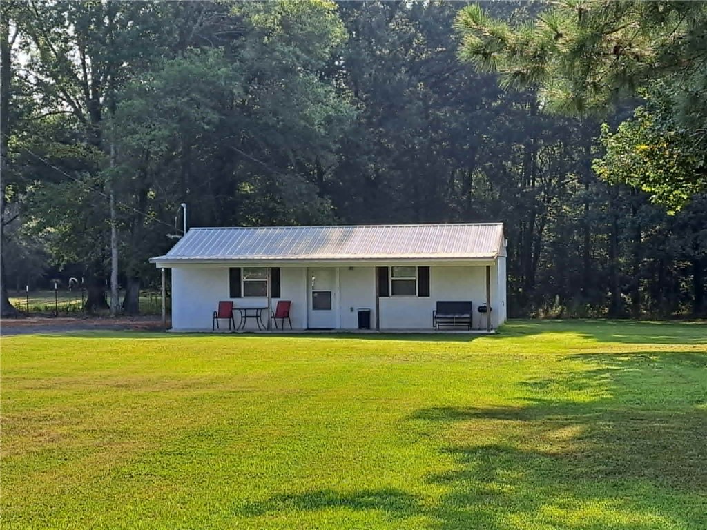 This compact studio-style home on 1.5 acres features an efficient open living space with one full bathroom, making it the perfect low-maintenance retreat or income-producing opportunity. A standout feature of this property is the separate 50-amp RV hookup complete with its own septic system already in place — ideal for additional rental potential, guest accommodations, or a travel trailer setup. With the growing demand for short-term rentals and tiny living spaces, this property is perfectly suited for an Airbnb or dual-income investment opportunity. Enjoy the privacy and charm of country living while still being conveniently located near town. The home may also be purchased fully furnished, making it move-in or rental-ready from day one. It also offers a storage building. Enjoy the privacy and charm of country living while still being conveniently located near town. The home may also be purchased fully furnished, making it move-in or rental-ready from day one. It also offers a storage building.