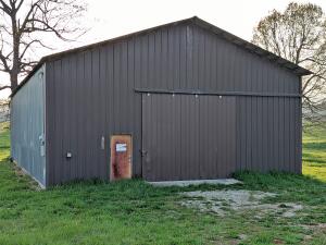 The possibilities are endless with this warehouse/manufacturing facility on major Highway with high traffic count, concrete floor, bathroom, 3 phase electricity & loading dock outside of city limits.   All #s are approx., age is estimate, square footage per assessor, buyer to verify existence of septic.