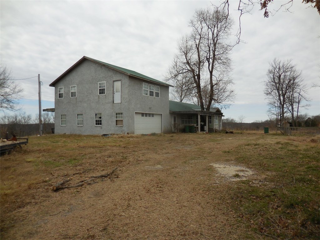 Unfinished home on 39 acres with exceptional view and beautiful building sites. Private location yet convenient to I49 and Devils Den State Park. Good potential for your hunting lodge. A 3rd bath has plumbing but no fixtures. Sold AS IS. Suggest "in house" financing.