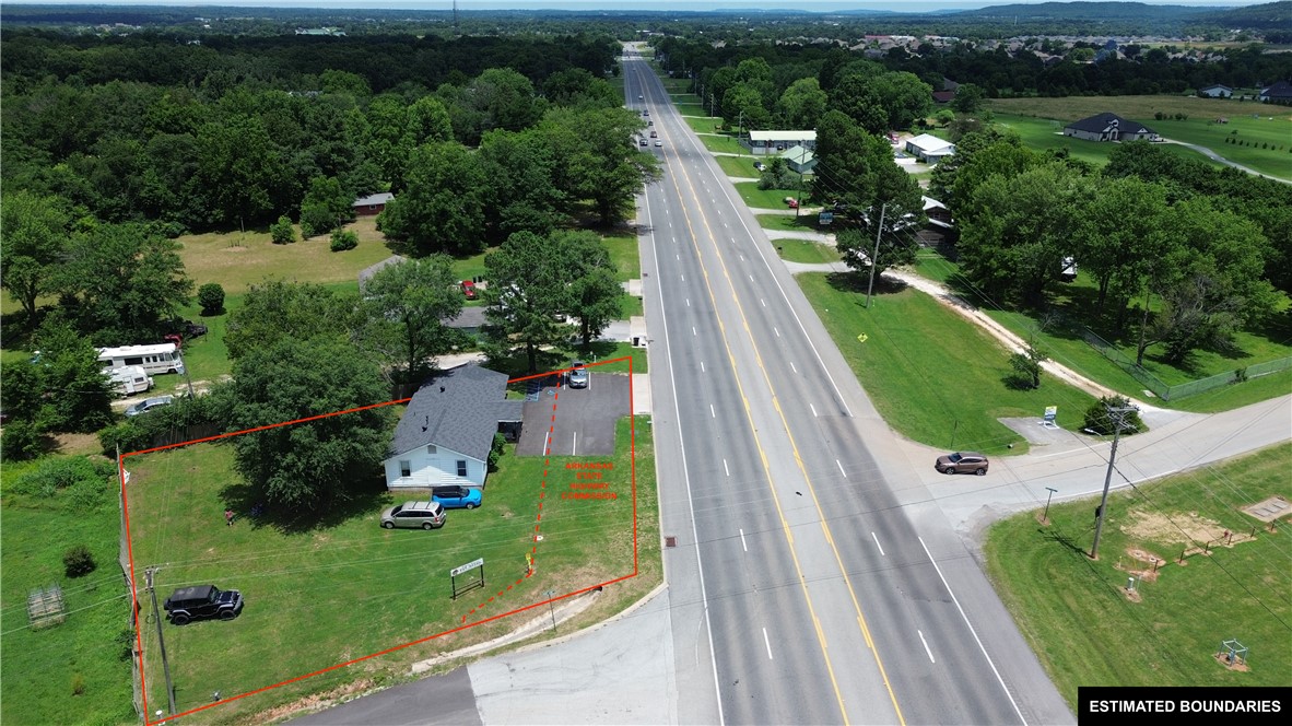 Investor opportunity with an income-producing tenant already in place, providing immediate cash flow from day one. Zoned Mixed Use B-2, this property offers flexibility for a variety of future uses while benefiting from a highly visible corner location at the intersection of the recently paved Buddy Elkins Road and Highway 62. With approximately 20,000 vehicles passing by daily, the property enjoys exceptional exposure and strong long-term investment potential. Additional features include paved parking, excellent accessibility, and a strategic location in a growing corridor. The property has a Farmington mailing address but is located within the Prairie Grove city limits.