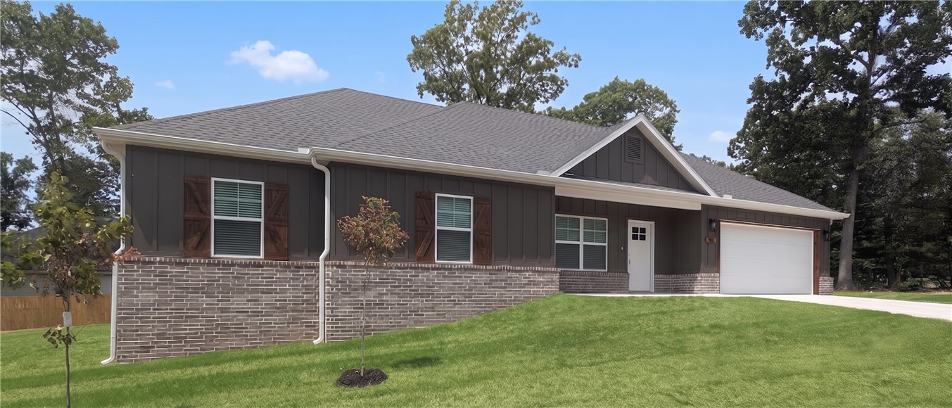 This stunning residence combines contemporary board and batten design with a classic brick skirt, offering premier curb appeal near Highlands Golf Course and the shores of Loch Lomond. Sitting on almost a half-acre of land, this property boasts an expansive backyard with endless possibilities—whether you want to build a massive detached shop, or simply need tons of room for the kids and fur babies to run and play. This move-in-ready gem perfectly blends high-end finishes, incredible outdoor freedom, and an unbeatable Bella Vista location.