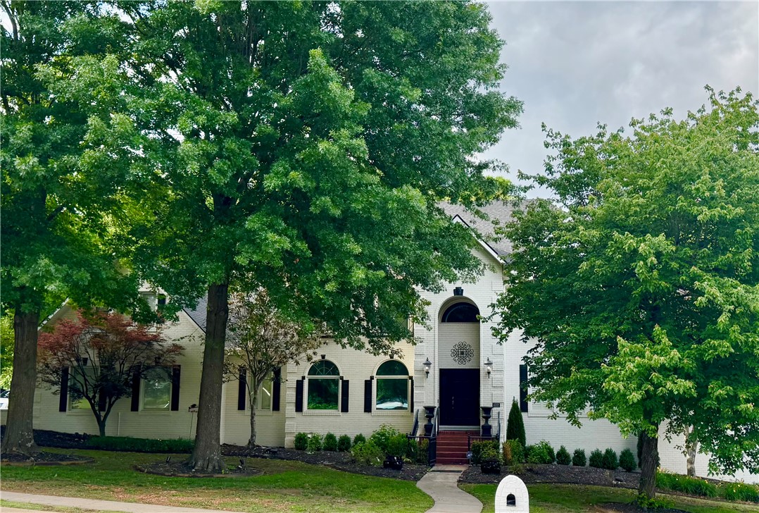 Situated on a private 0.79-acre lot in a desirable neighborhood, this beautiful home offers convenient access to everything NWA has to offer. The grand entry welcomes you into a formal living room with a fireplace, while the elegant dining room features arched windows & architectural details. A private office with French doors & hardwood floors provides an ideal workspace. The family room includes hardwood floors, a second fireplace, & opens to the breakfast nook/large kitchen with built-ins, center island, breakfast bar, & storage. Two patio doors lead to a deck overlooking the expansive backyard. The primary suite offers hardwood floors & a spacious en-suite bath. Upstairs, the bonus room with built-ins is perfect as a media or game room. The fully finished basement provides endless possibilities for recreation, hobbies, guests, or additional living space. This exceptional home combines timeless style, generous living areas, & an location. Professional photos coming soon! Showings not to begin until 7/17.