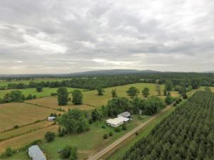 Views of the River Valley surrounds this 3bd 1ba farmhouse on 28 acres with an income producing mobile home included.  Property equipped with fruit trees, outbuildings, and farming equipment to convey.