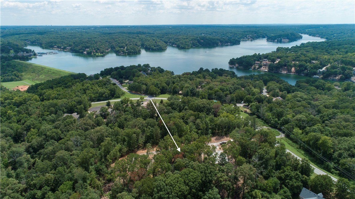 Kilninan Lane is .33 acres of slightly sloped and wooded land. The lot itself is sitting 18-24 inches above the roadbed. The cul-de-sac is located in an area that sees minimal traffic. The lake can be seen in the overhead shots, only 0.2 miles away from the residence. The Lake Point Marina and fishing dock is 4 minutes away by car (1.5 miles) - or a 25 minute walk. The Scottsdale golf course is another 3 minute drive (1.5 miles). The Branchwood community center is 3.7 miles/8 minutes by car and features walking trails, tennis courts, shuffleboard, a basketball court, a large rec center, and a frisbee golf course.