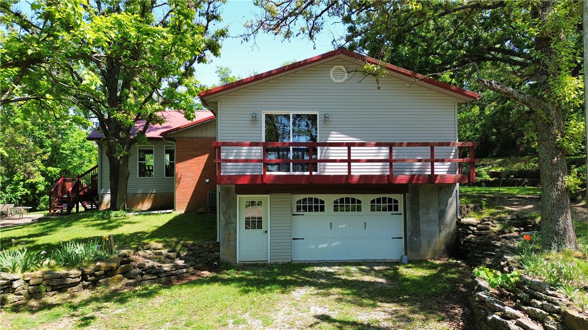 Easy commute, rare opportunity, come see this property!! **Sellers to provide a $5,000 seller concession at closing**Beautiful park like setting on 2 acres m/l sprinkled with mature trees surrounding a prime multigenerational opportunity just under 5 miles from Huntsville! This expansive home boasts 7 beds/4.5 baths total, 4/4 upstairs, featuring a great layout with elevated front-yard views. 20X30 metal storage building. The real bonus is the versatile lower level with its own private garage access, approx 1462 sq ft great for a dual-living suite, mortgage helper, or income-generating rental. Discover endless possibilities for income and flexible use—come see it today! 
Great location off of hwy 74 for easy commuting all over NWA!!!