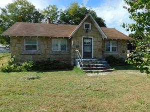 Flagstone home with 18 x 20 ft detached garage. Property includes 2 near level lots, back yard has 3 pecan trees, a fig tree in back left corner, and grapevines, plus an apricot tree in front yard. Convenient location near central Harrison.
