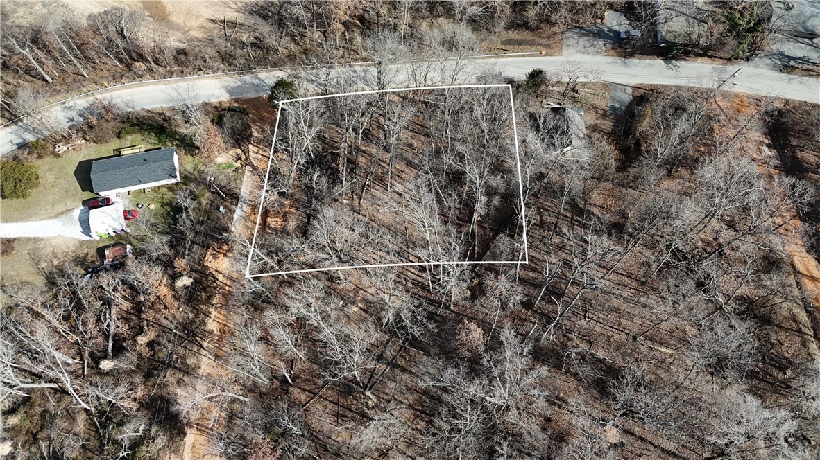 Create your dream home on this stunning lakeview lot, offering nearly a quarter of an acre of endless possibilities. Just 10 minutes from downtown Rogers, this location combines convenience with tranquility, making it the perfect place to build your ideal retreat. Imagine large windows that frame the picturesque scenery and a spacious deck for outdoor enjoyment.