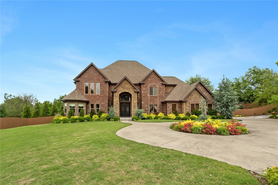This custom built, three-level estate truly has it all. As you enter this home you are greeted by a grand foyer with soaring ceilings, featuring a split staircase, with a built-in water feature. The main level includes: a formal living and dining room, a guest suite, a full bathroom, a great room featuring a two-story ceiling with expansive windows, an eat-in kitchen with granite countertops, and top of the line appliances. From the kitchen you can access the outdoor living spaces with a back deck overlooking lush trees, a fire pit, and a gate that leads to walking/biking trails. The top floor features: three bedrooms with two en-suite baths, a luxury master bedroom with a private balcony, master bath with separate vanities, soaking tub, his and her closets, and a walk-in shower. The basement features include: a large rec room with a kitchen, a theater, exercise  and craft room, and doors that lead to an outdoor patio. It is in the gated Creekside Subdivision with community pool. Schedule a private tour today!