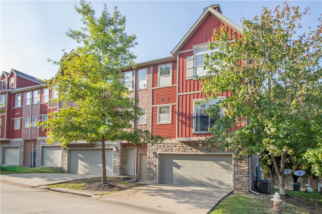 Low maintenance living is here! Enjoy the convenience of a condo that is close to all the amenities. Near the University of Arkansas, shopping, restaurants, and the highway- everything is just a 5 min drive away. This 3 story, 2 bedroom, 2.5 bath property features a 2 car garage, comfortable layout, and plenty of natural light! And you won't have to worry about taking care of the yard or exterior. Just hop onto the nearby trails and head into Centennial Park for a break from the hustle and bustle. Ideal student rental, investment, downsize, or first home! New flooring throughout and carpet on the stairs done in 2024.  New paint in 2025. Condo financing available through Stephanie Bevard First Colony Mortgage!