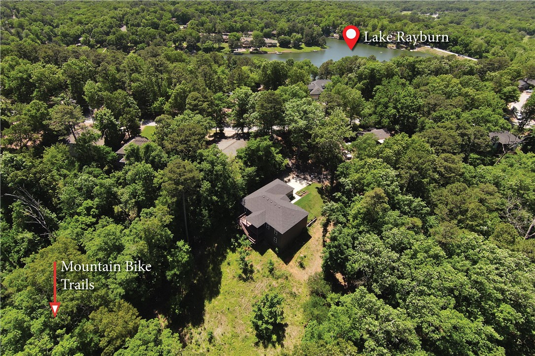 Tucked into a private & quiet nook on an expanded 1.03-acre setting. You'll walk past the koi pond into a kitchen with a gas range, quartz counters, custom cabinetry & an oversized island. Downstairs, this spacious 3-bed home offers another living/flex space plus a bonus room for exceptional utility. Foggy mornings bring mist into the tree line which sellers liken to sitting on a cloud. Whole-home filtration & RO filter, organic yard, wood floors & decks. Adjoining homesite adds privacy where you can ride straight from the backyard onto the trail.