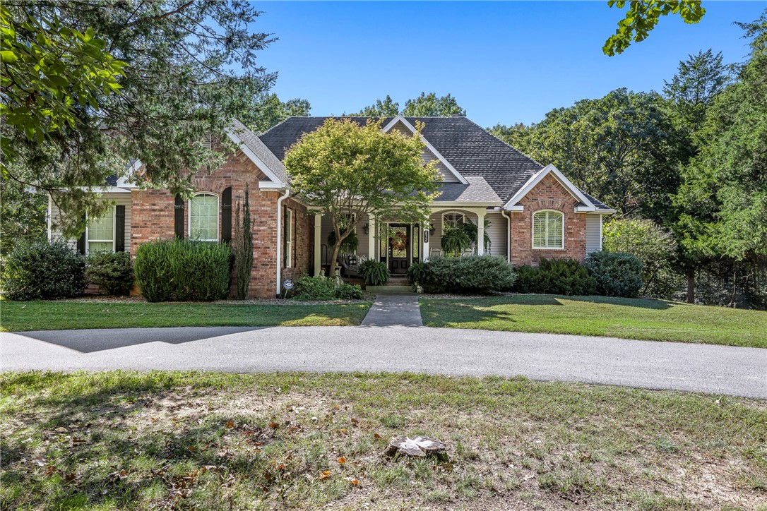 Prime location 3 minutes to Downtown Rogers/Lake Atlanta 5 Minutes to Prarie Creek boat dock. From the time you step into the foyer to a cozy living space for all your gatherings to the vaulted ceilings/stone fireplace this home has it all.  A modern kitchen with a large island w/prep sink, 5 burner gas stove & pot filler, breakfast bar, walk-in Panty & covered deck for all your grilling.  Master BR main level with large Master bath , walk-in shower, double shower heads, his & hers walk-in closets and a door way to your covered deck for your coffee in the a.m. & your glass of wine in the p.m. 2nd Master suite w/bath downstairs could be mother-in-law quarters.  Large family room w/ wood burning stove w/built-in office desk & computer hook ups & wine/soda fridge. Two more guest Bedrooms with full bath & covered patio downstairs.  Just steps away is your 1800 sq ft. heat, kitchen /bath shop for your RV or use for a pickle  ball court.  This all sits on 7 + Acres.  Call for a private tour of a very unique place.
