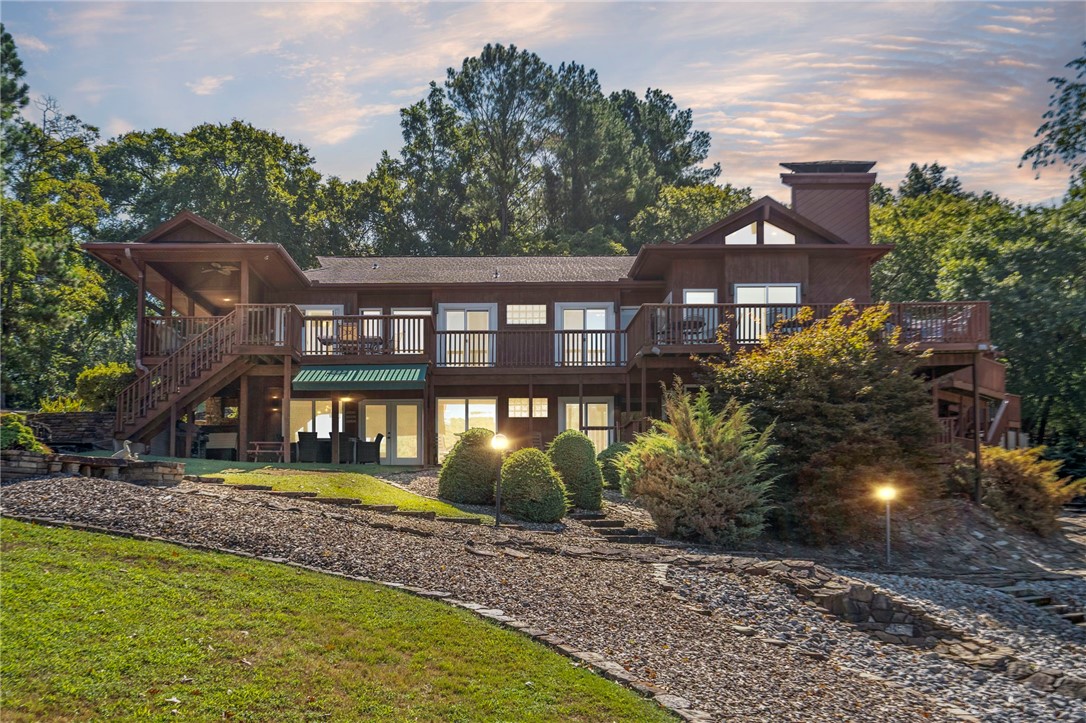 Enjoy Lake Windsor living with over 400 ft of shoreline in Bentonville Schools! This home offers peace of mind with fresh exterior paint and many updates: HVAC units (2016 & 2020 Paschal care) water heater (2020), fireplaces services recently and septic pumped/inspected July 2025. Landscaping has been refreshed, with electric deck awning and a lake loop system for irrigation and the backyard fountain. Outdoor living is unmatched with a 24' x 36' screened pavilion overlooking the water, perfect for entertaining, relaxing and soaking in the stunning views. With all the essentials cared for you get the oppportunity to add your own touches and make Windsor Point truly yours. A rare Bella Vista lakefront opportunity.