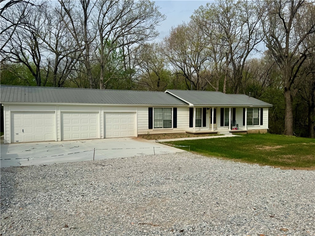 Ranch style home in Springdale fully remodeled - Move-In Ready!  This home has been updated from top to bottom.  Upgrades included brand new deck on back of home 14x49 perfect for entertaining and over looking nothing but nature.  3 Bedrooms 2 baths split BR floorpan.  Large LR with new ceiling fans and new flooring with extra padding.  New HVAC system, new paint inside and out.  2 new garage doors with new driveway, sidewalk that goes to front porch and around to back of home.  New retaining wall and underneath home has new water lines with storage area. Kitchen has new gas range, dishwasher and garage disposal.  Whether you're looking for comfort, style or a great outdoor space - this one checks all the boxes.  Don't miss it!