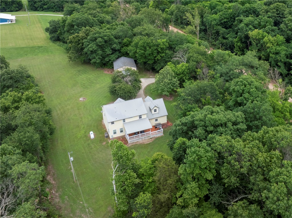 Welcome to this secluded paradise you could call home. It's a beautifully built country home built in 2004 that sits just far enough from town to feel quiet, but close enough that it's convenient to town. The house spans 2,528 sq ft, offering a balanced layout that feels roomy without being excessive, with warm, inviting proportions throughout. Inside the home it has clean lines, tasteful finishes and feels cozy the moment you step inside. The home has 3 bedrooms and 2.5 baths with a huge living room for entertainment. It has an office and bonus room for extra space to enjoy or to have a workspace. Two of the bathrooms were updated with new vanities, tile, sinks and paint. The carpet was replaced in 2023 with new carpet. It has plenty of space for outdoor activities or watching the wildlife from your huge deck. It has a shop with electric to store your equipment. Refrigerator, washer, dryer and the ring doorbell all convey with acceptable offer. Come and see this property before it's gone.