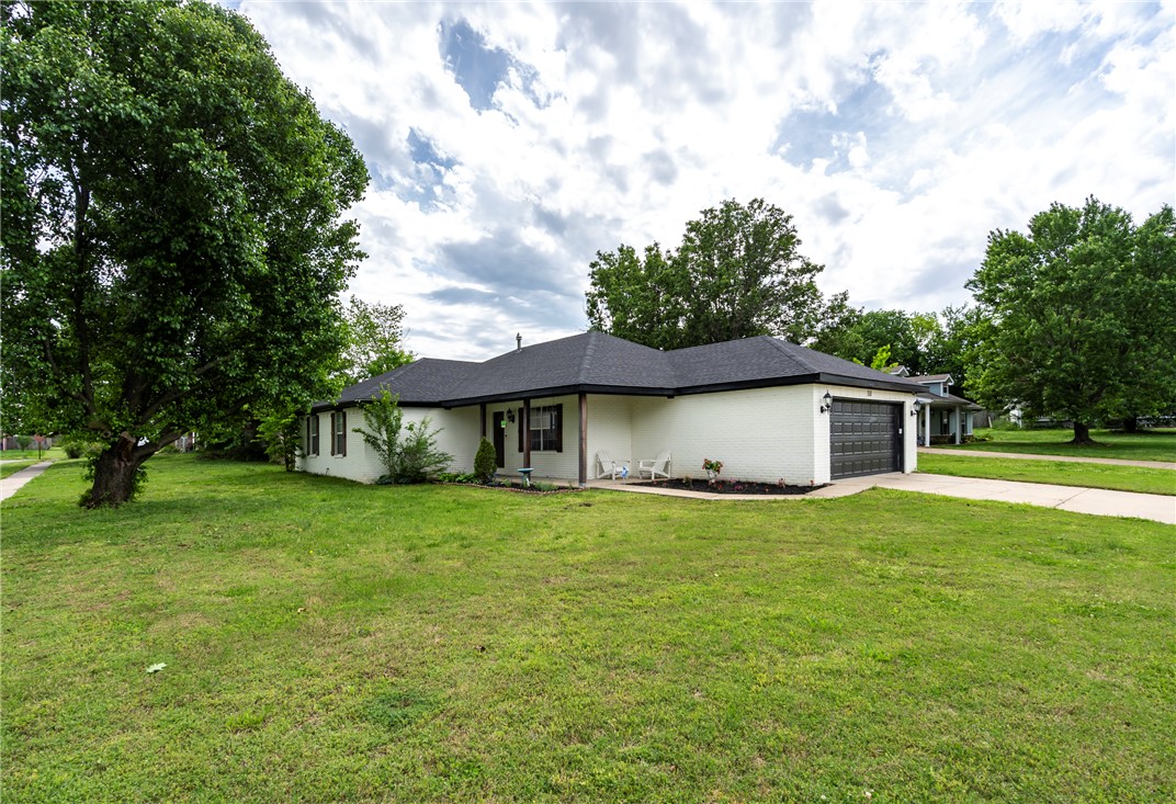 USDA, FHA, and Traditional financing Eligible!! $3,000 Preferred Lender Credit! Inviting all-brick home on a spacious corner lot in beautiful Prairie Grove, Arkansas- just minutes away from top-rated schools and the vibrant downtown area. This 3-bedroom, 2-bath home features vaulted ceilings with a central beam in the living room, plus an updated kitchen with granite counter tops along with two walk-in closets in the Primary bedroom.  Upgrades include a new roof, garage, and appliances- all in 2023. The backyard features a versatile storage building, perfect for a she-shed, hobby space, or extra storage. Move-in ready and nestled in a delightful small town setting- don't miss this gem! Only 12 miles to Fayetteville.